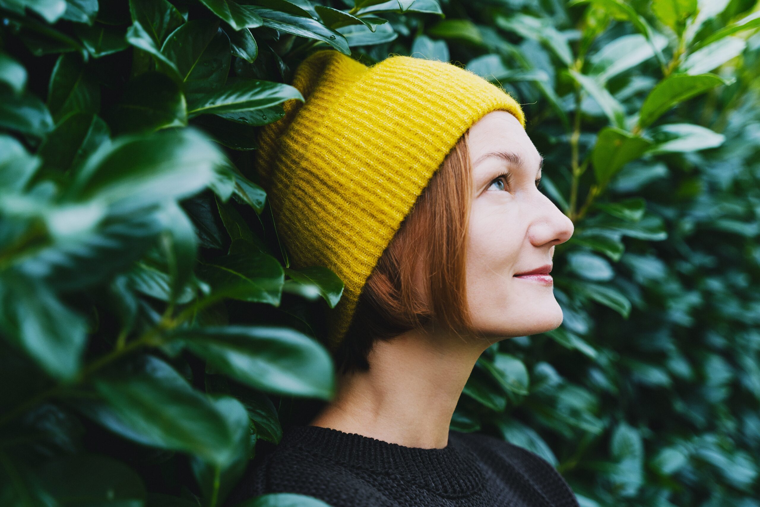 A stoic looking woman walking outside.
