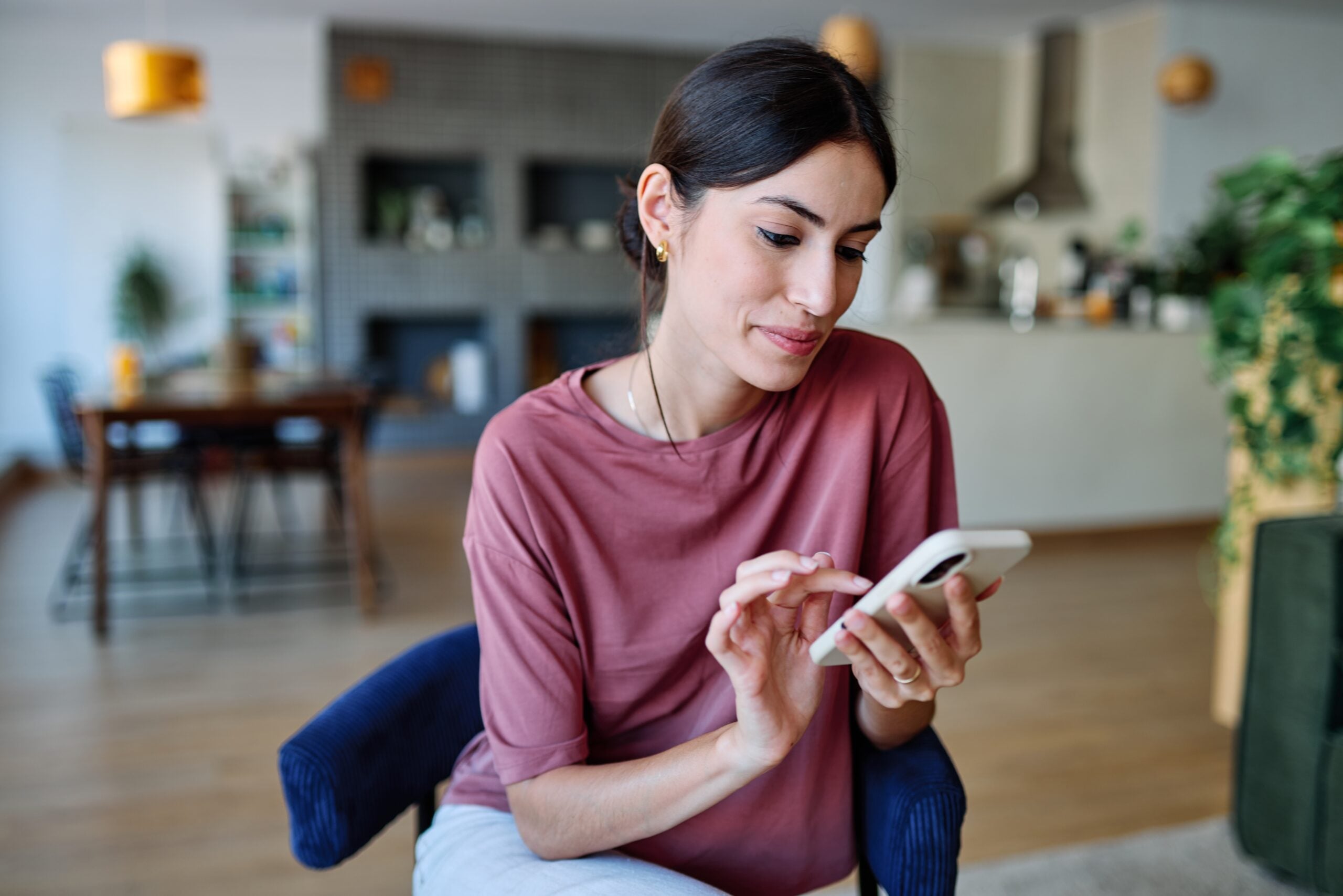 A woman scrolling through her social media.