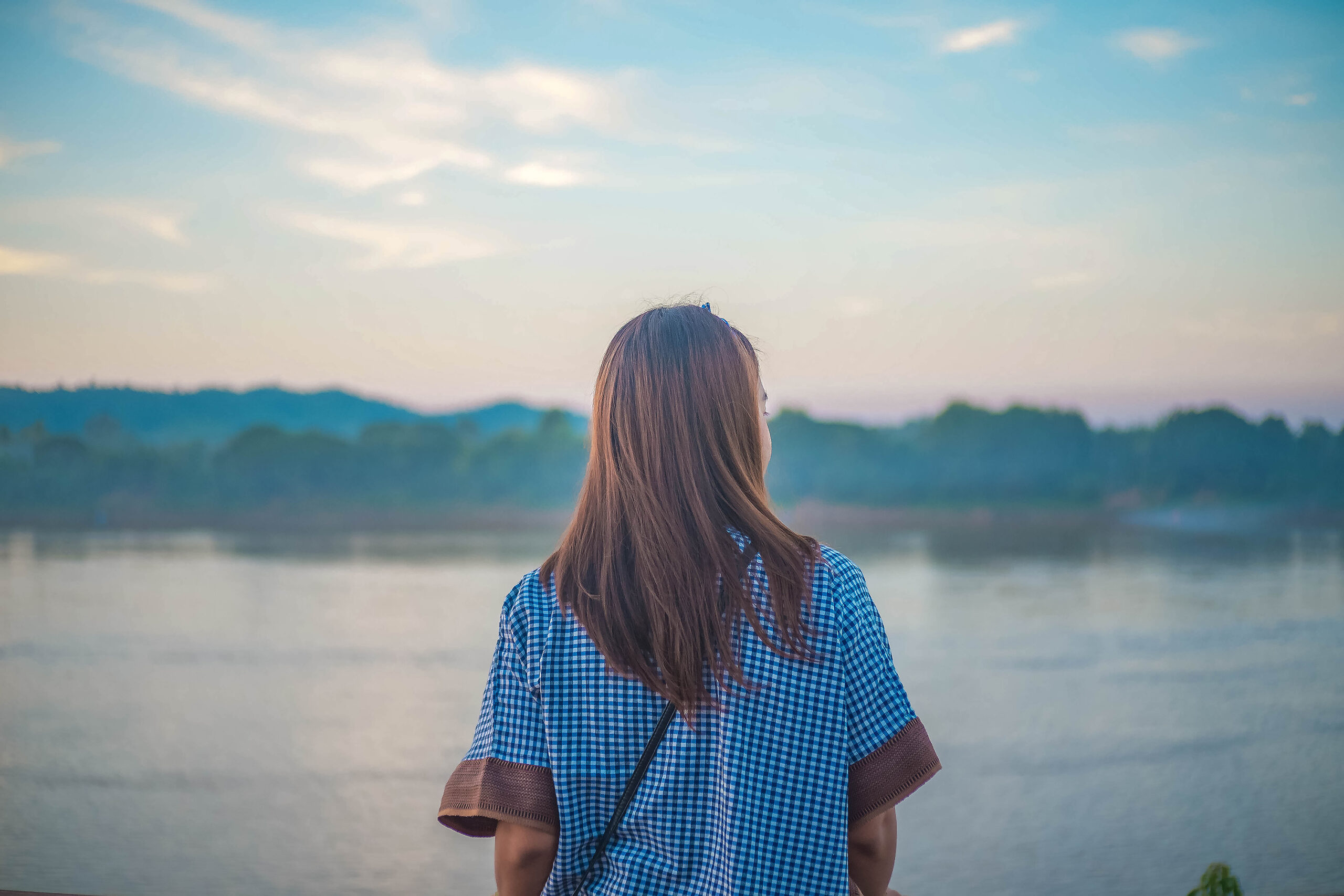 Woman solo looking at river view.