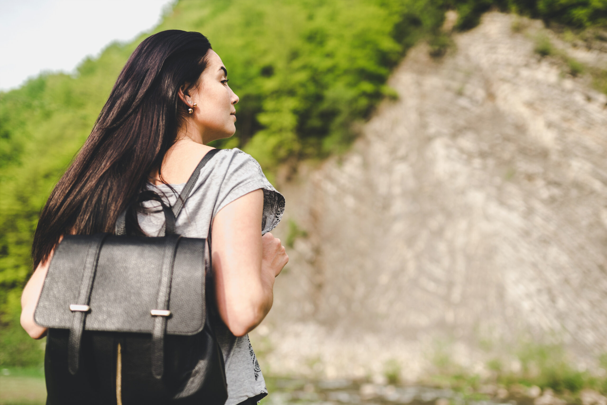 A woman on an outdoor hike alone.