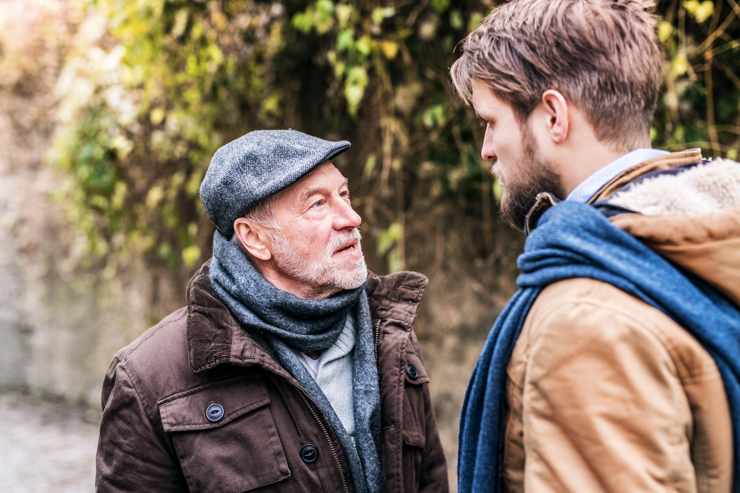 Senior father and his adult son on a walk having a serious discussion.