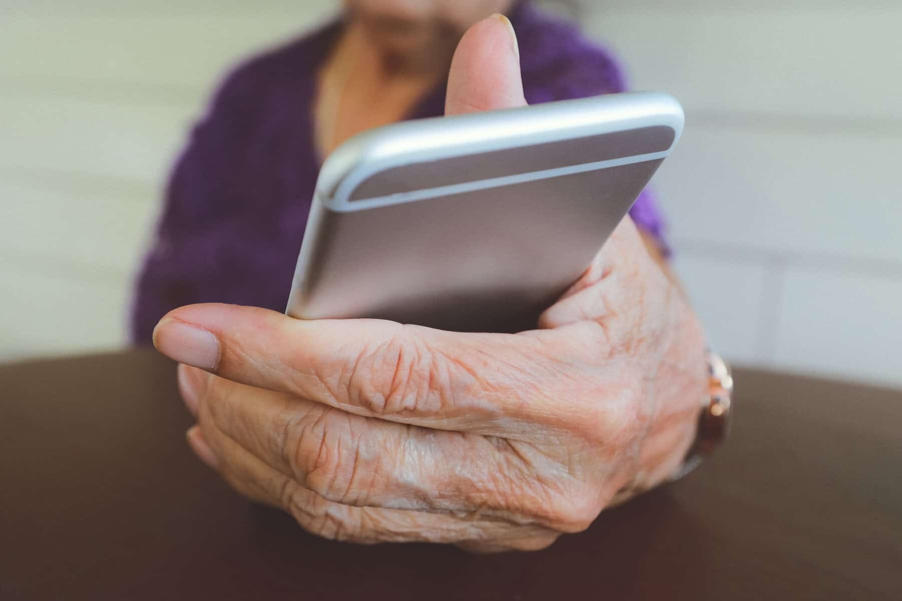 A senior woman receiving a message from her adult daughter.