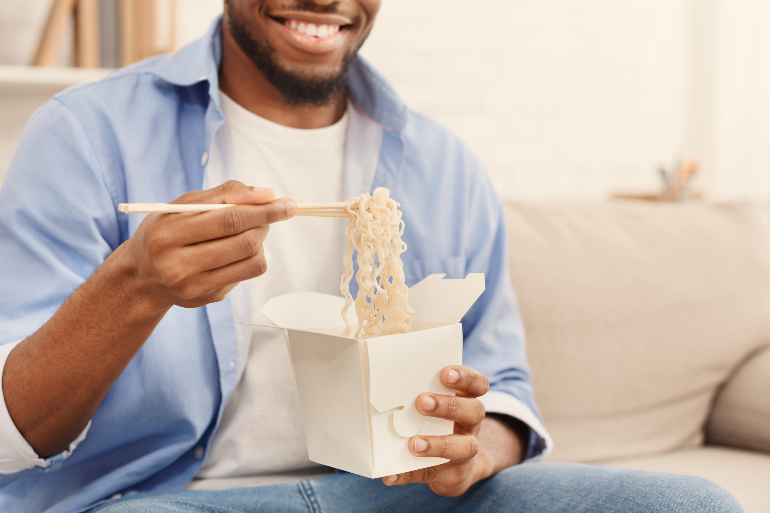 A single man enjoying takeout.
