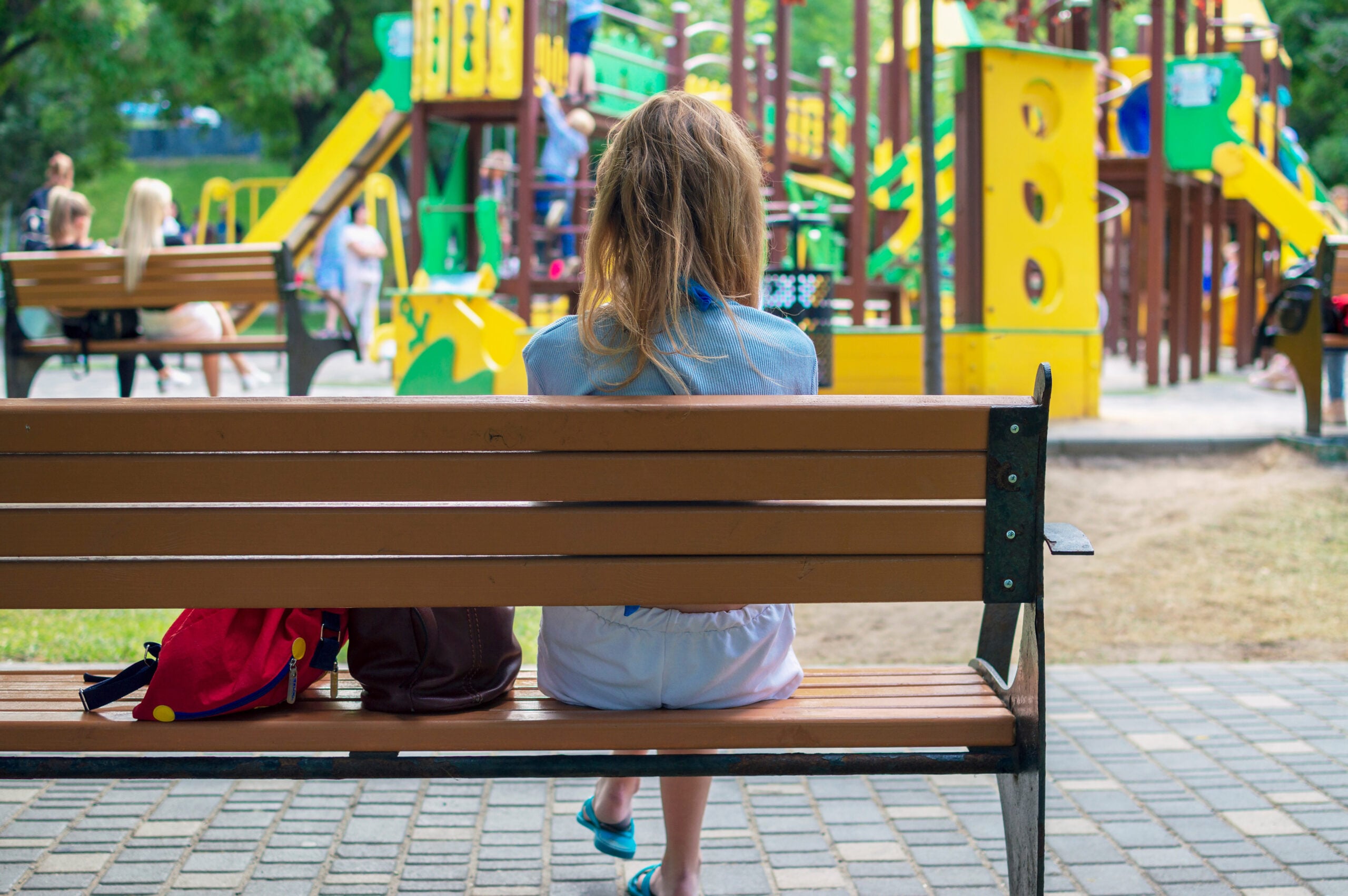 A single mother with her children at the playground.