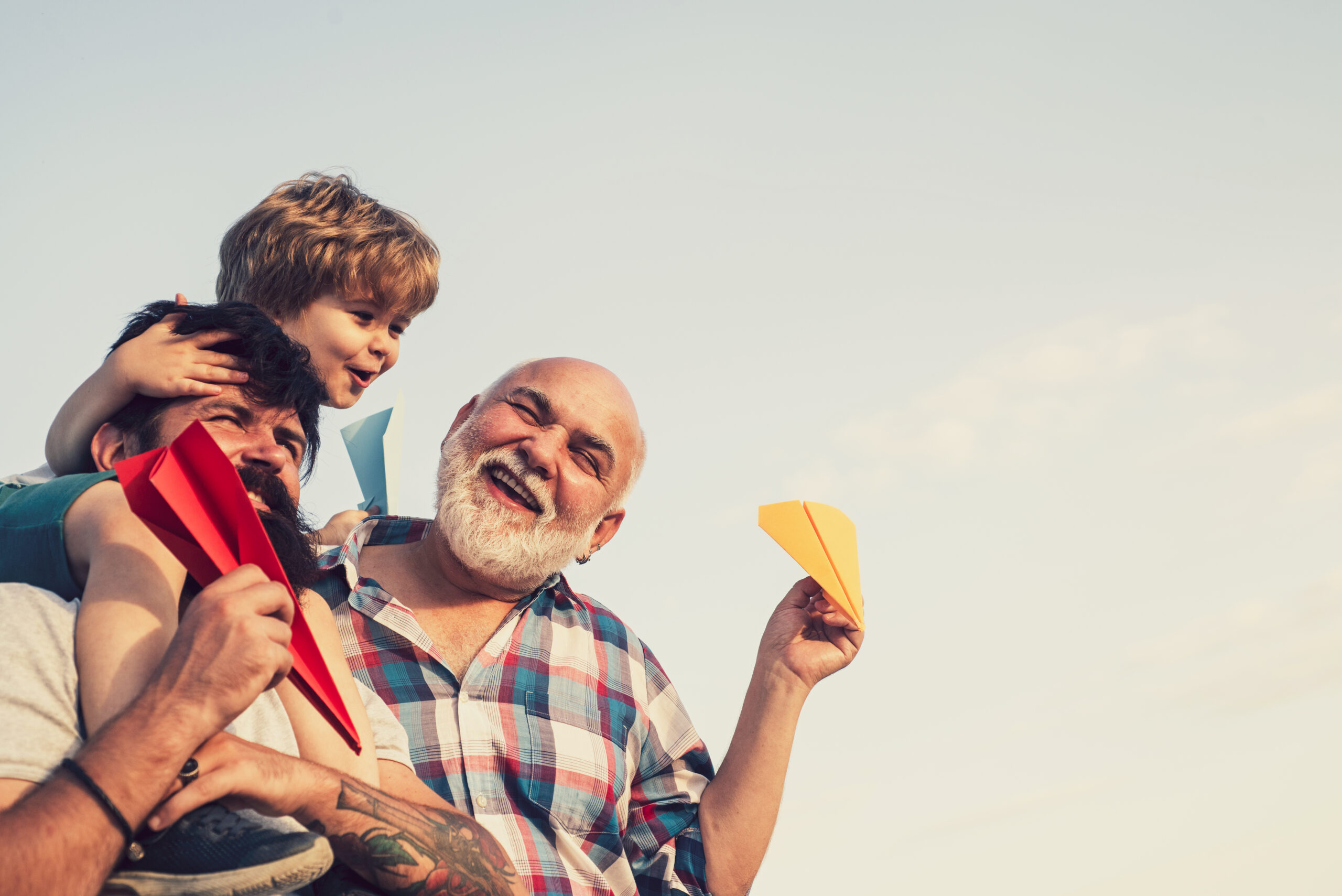 Three generations of men enjoying time together outdoors.