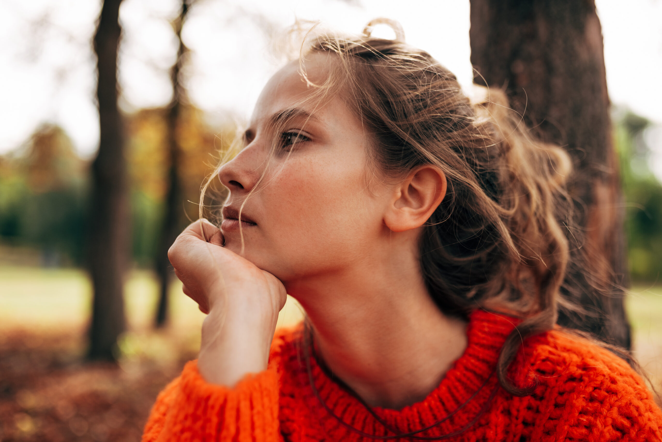 A young woman deep in thought about her family.