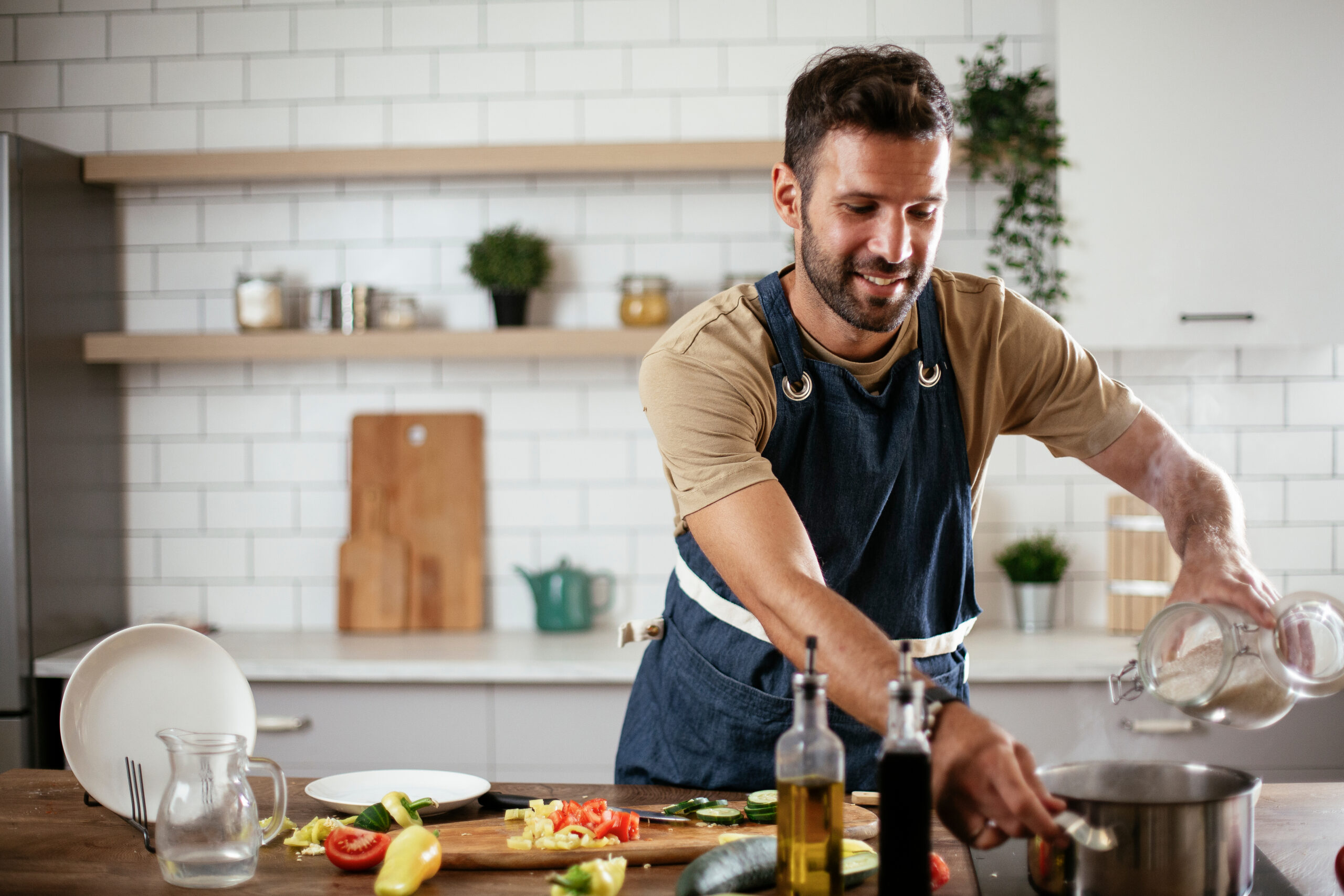 A man making dinner for his friends and family.
