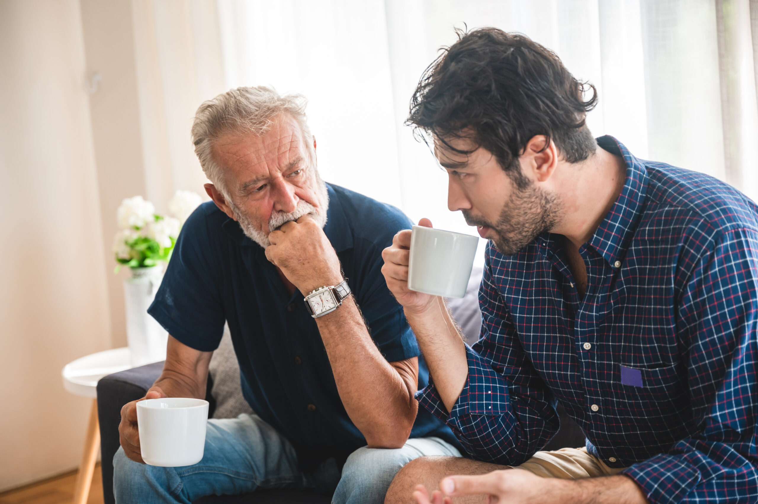 A senior father with his adult son having a heart to heart.