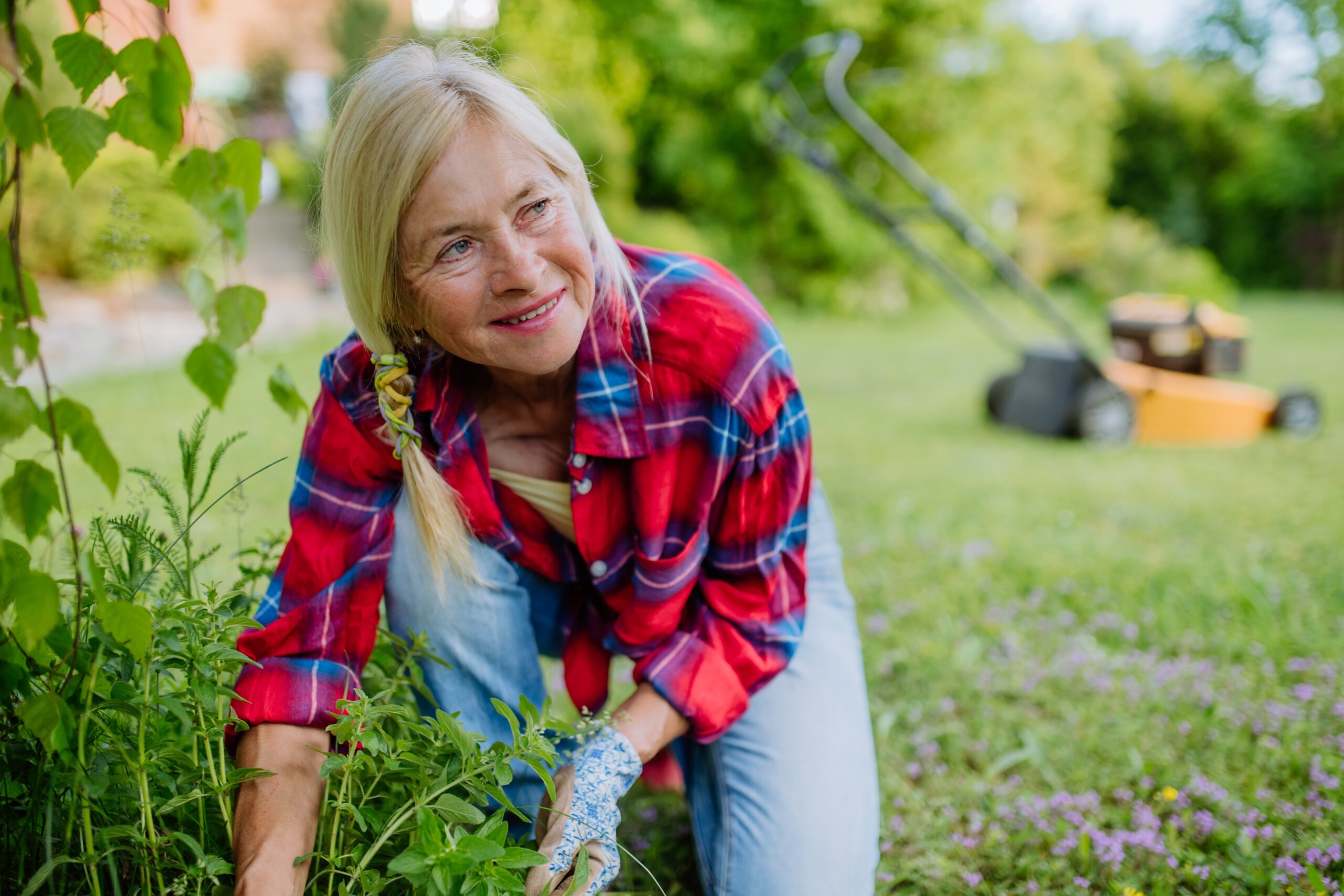 A patient midlife woman spending time in her garden.