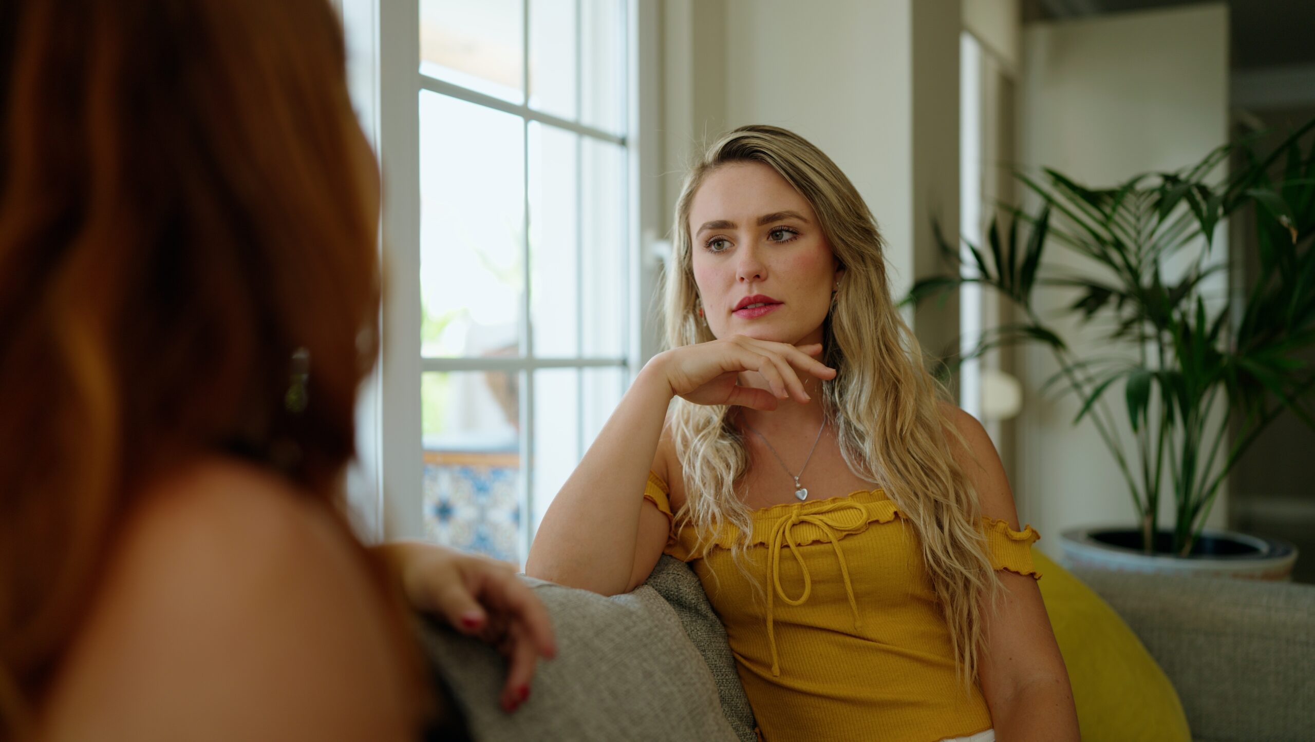 Two female friends having an honest and difficult conversation.