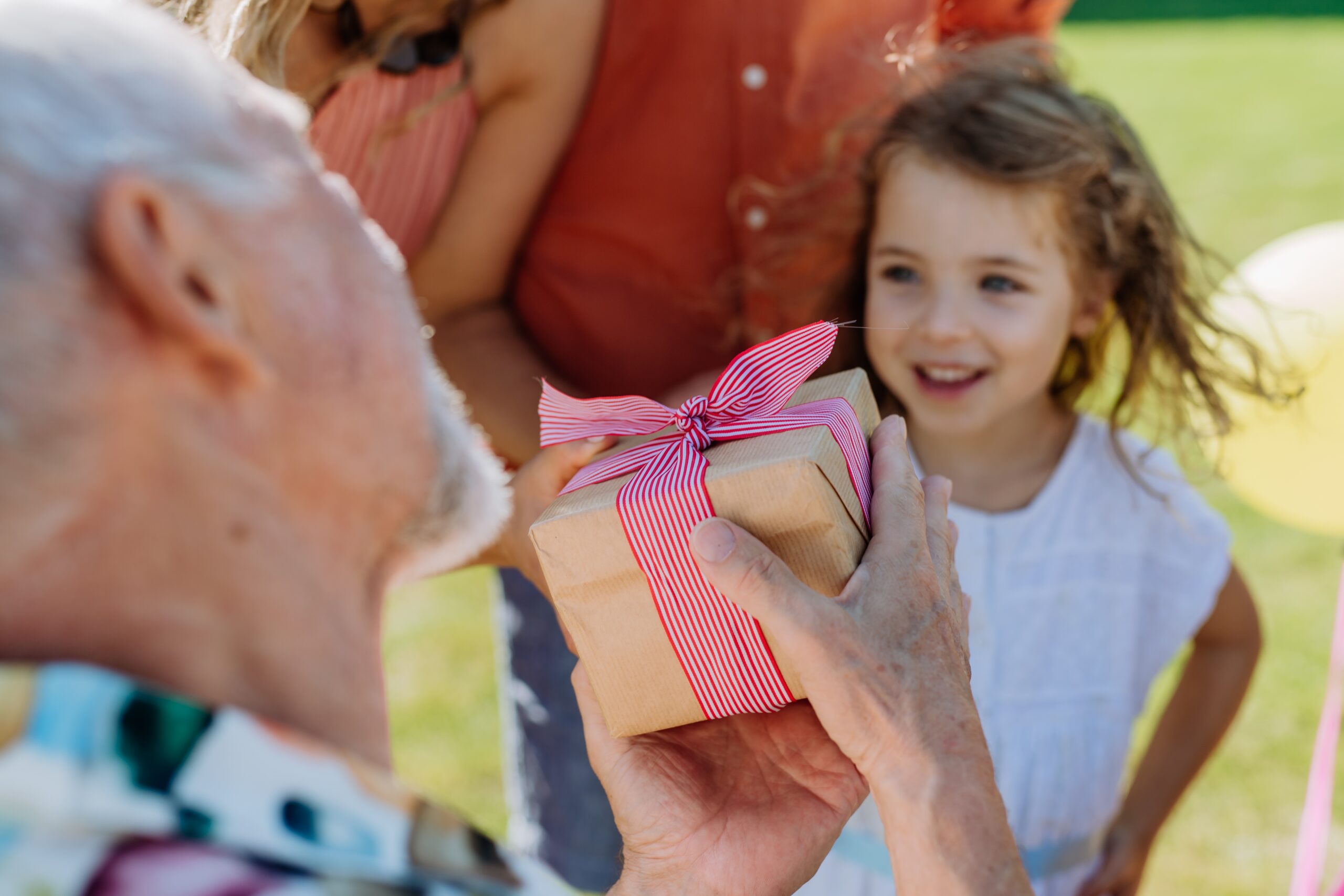 A grandparent spoiling his granddaughter.