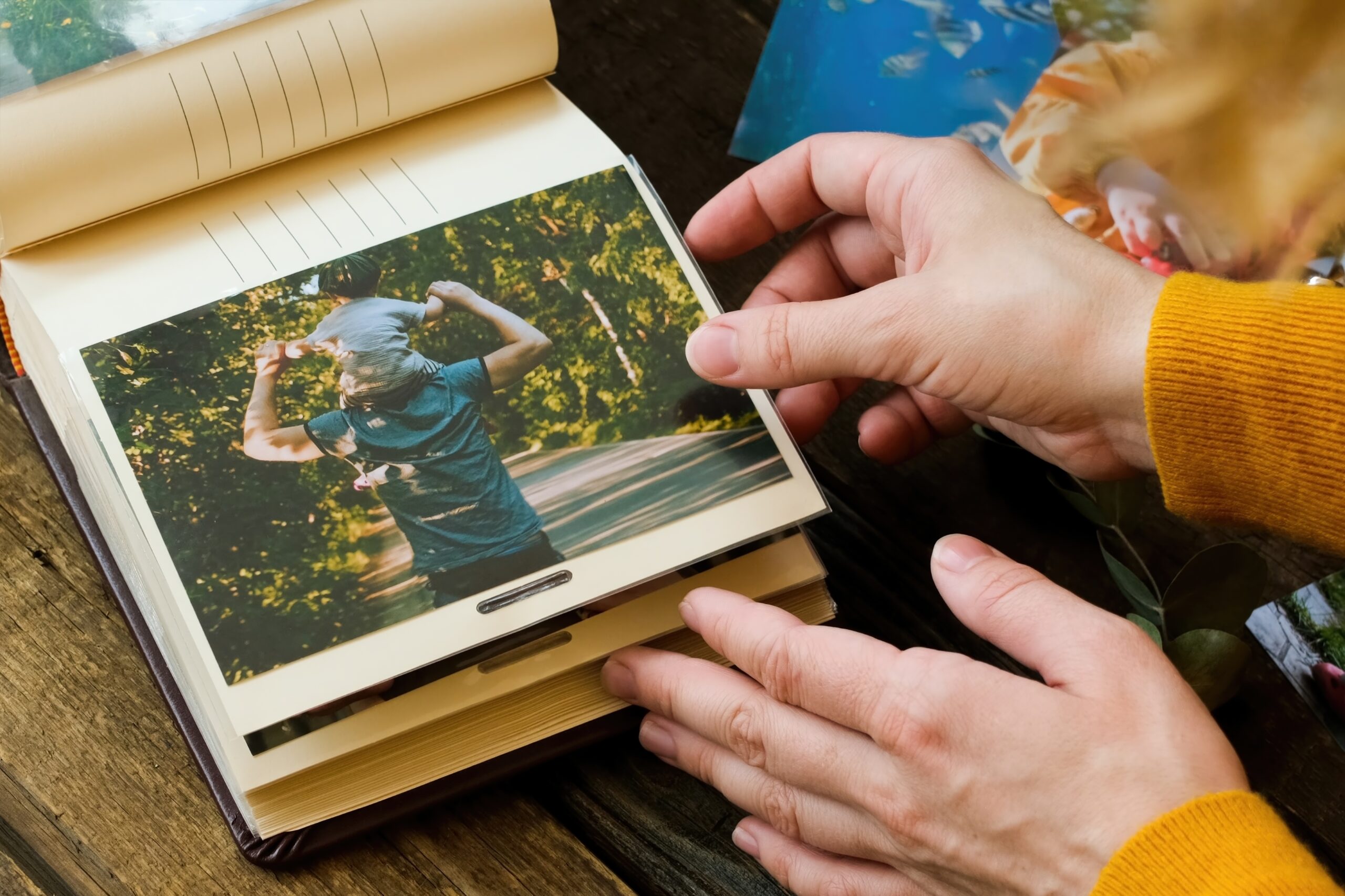 A mother and daughter looking through memories in an old photo album.