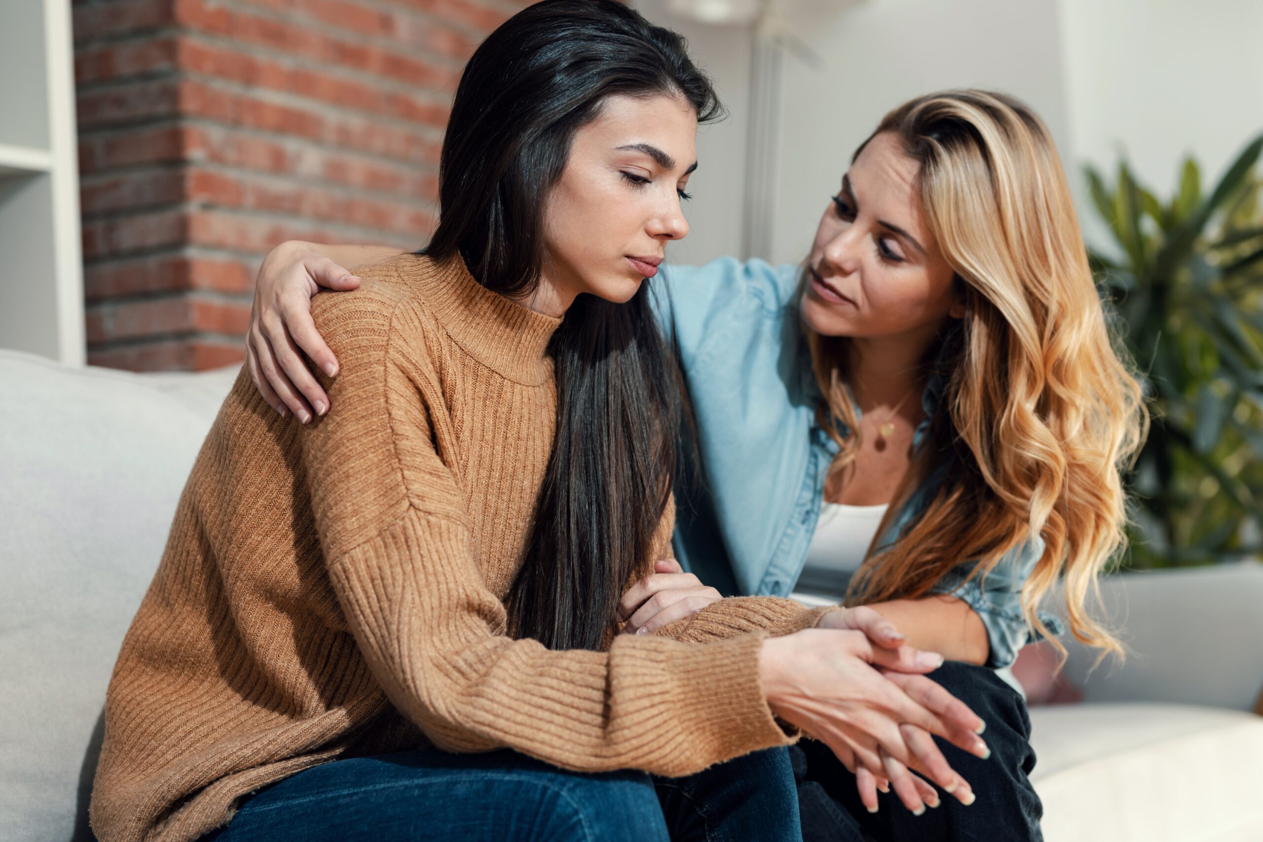 Two female friends lamenting about something difficult.