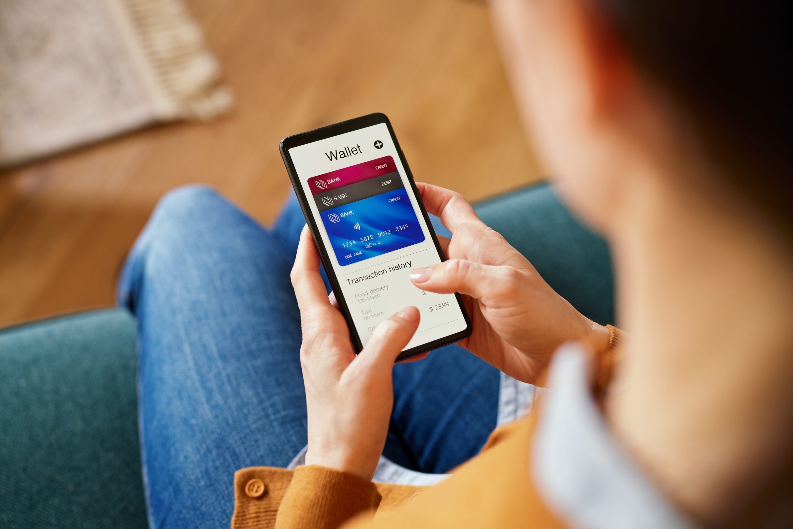 A woman using her smartphone to check the balance of her digital wallet.