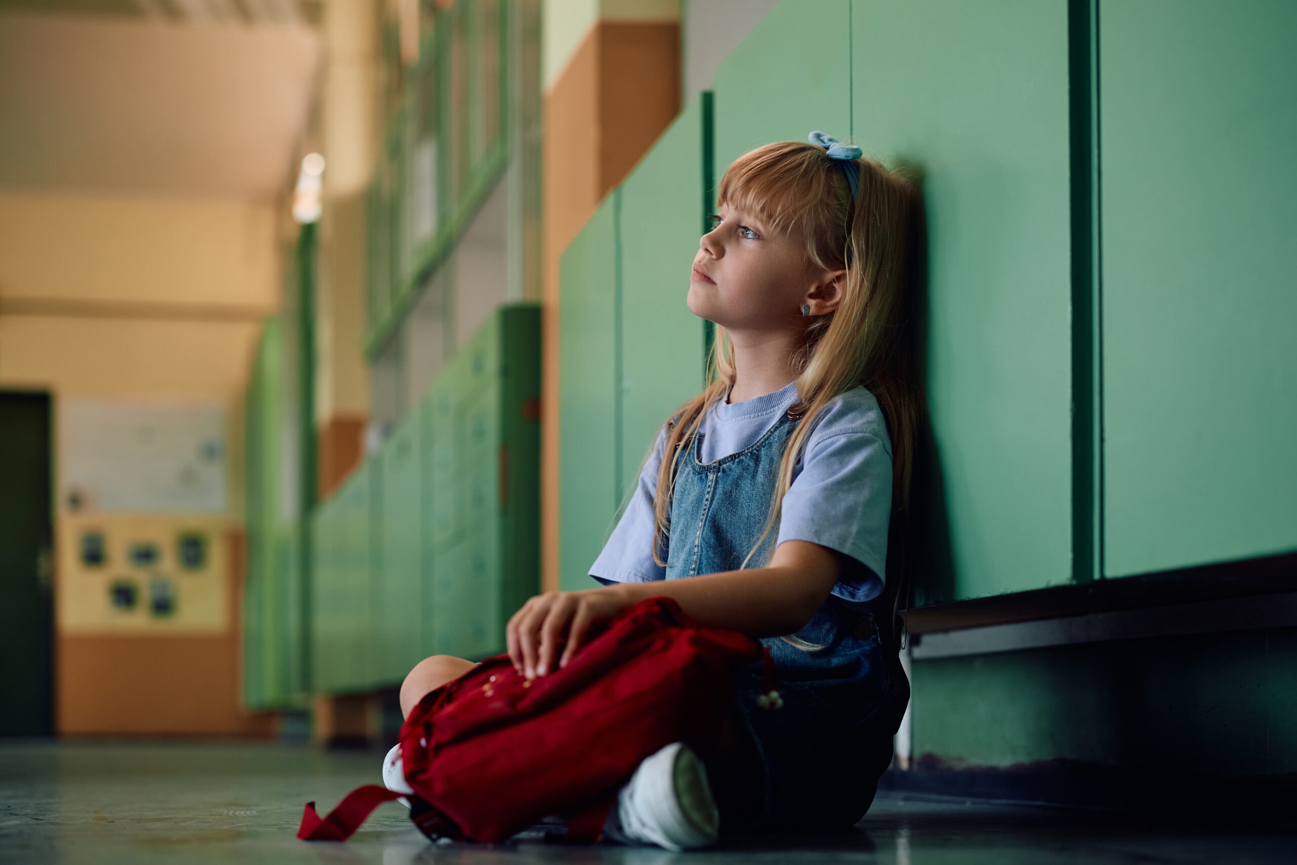 A child sitting alone at school.
