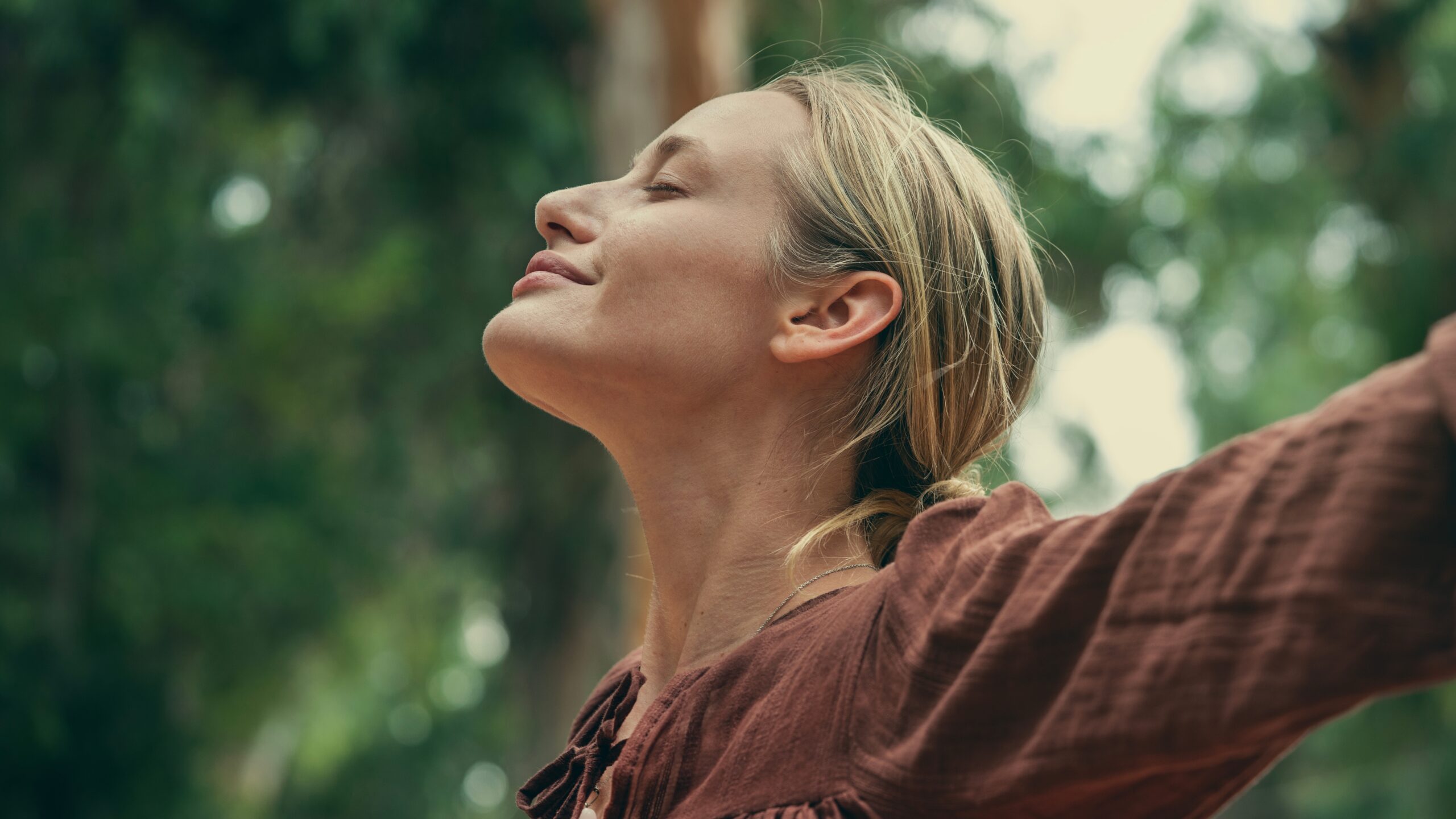 A woman breathing deeply to manage stress.