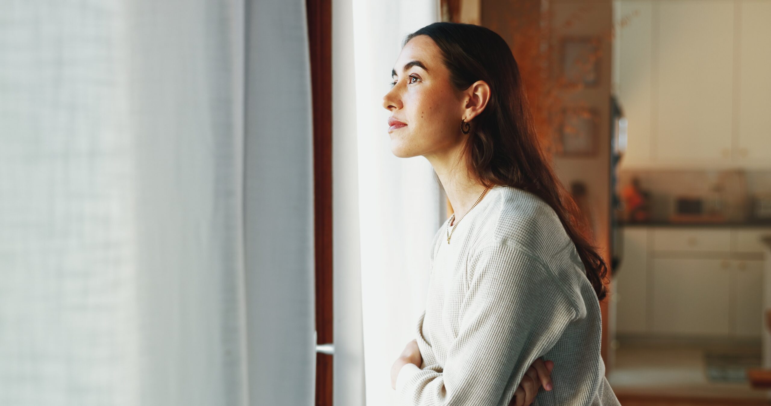 A woman at home alone thinking about her life.