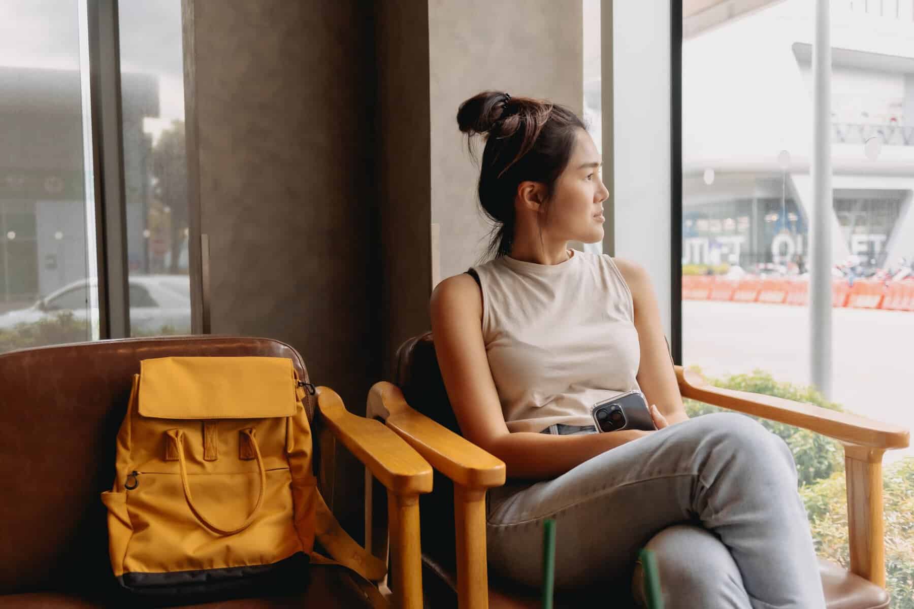 A woman sitting alone in a waiting room.