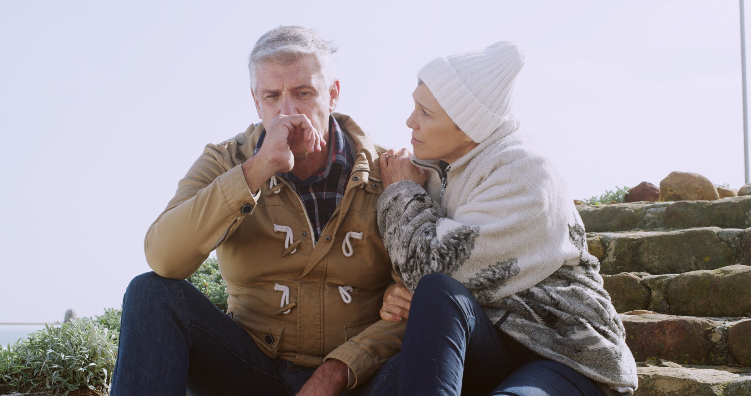 A senior couple sitting and thinking about life.