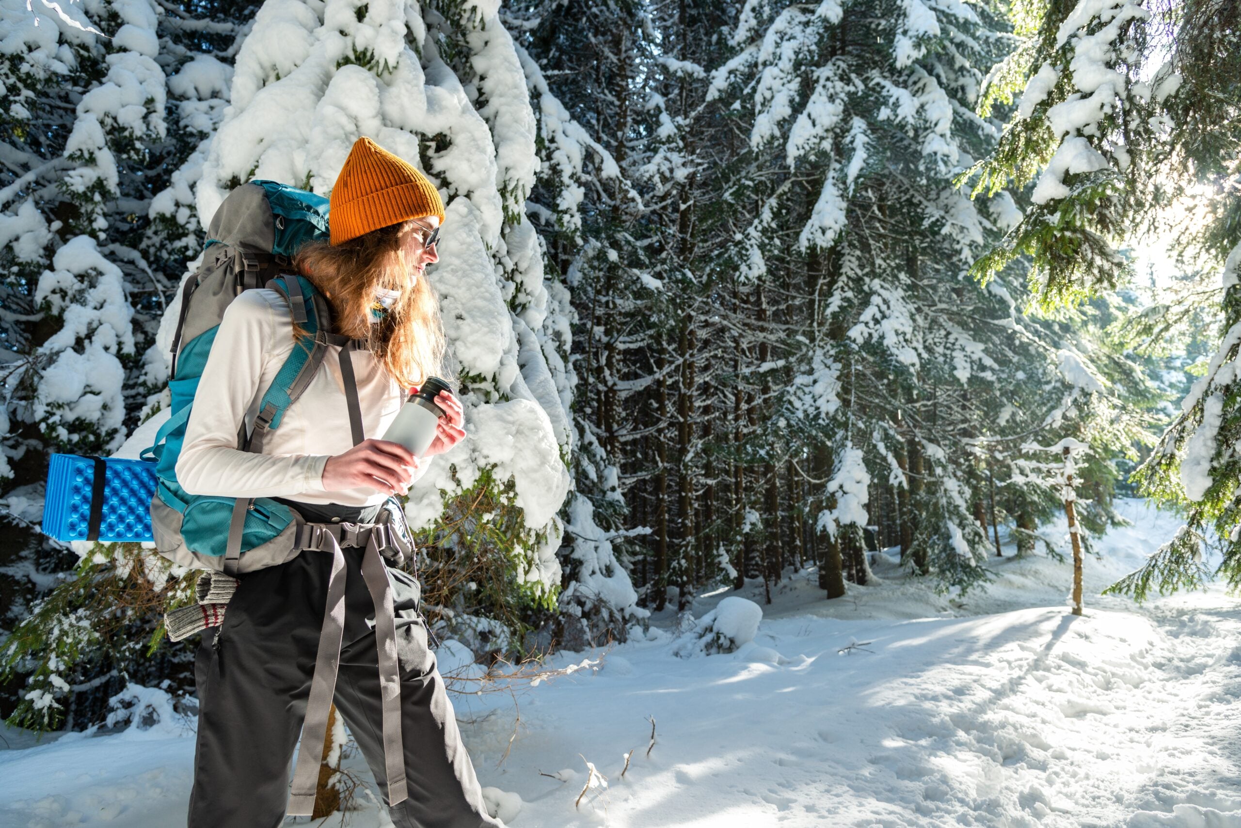 An independent woman hiking alone in the woods.