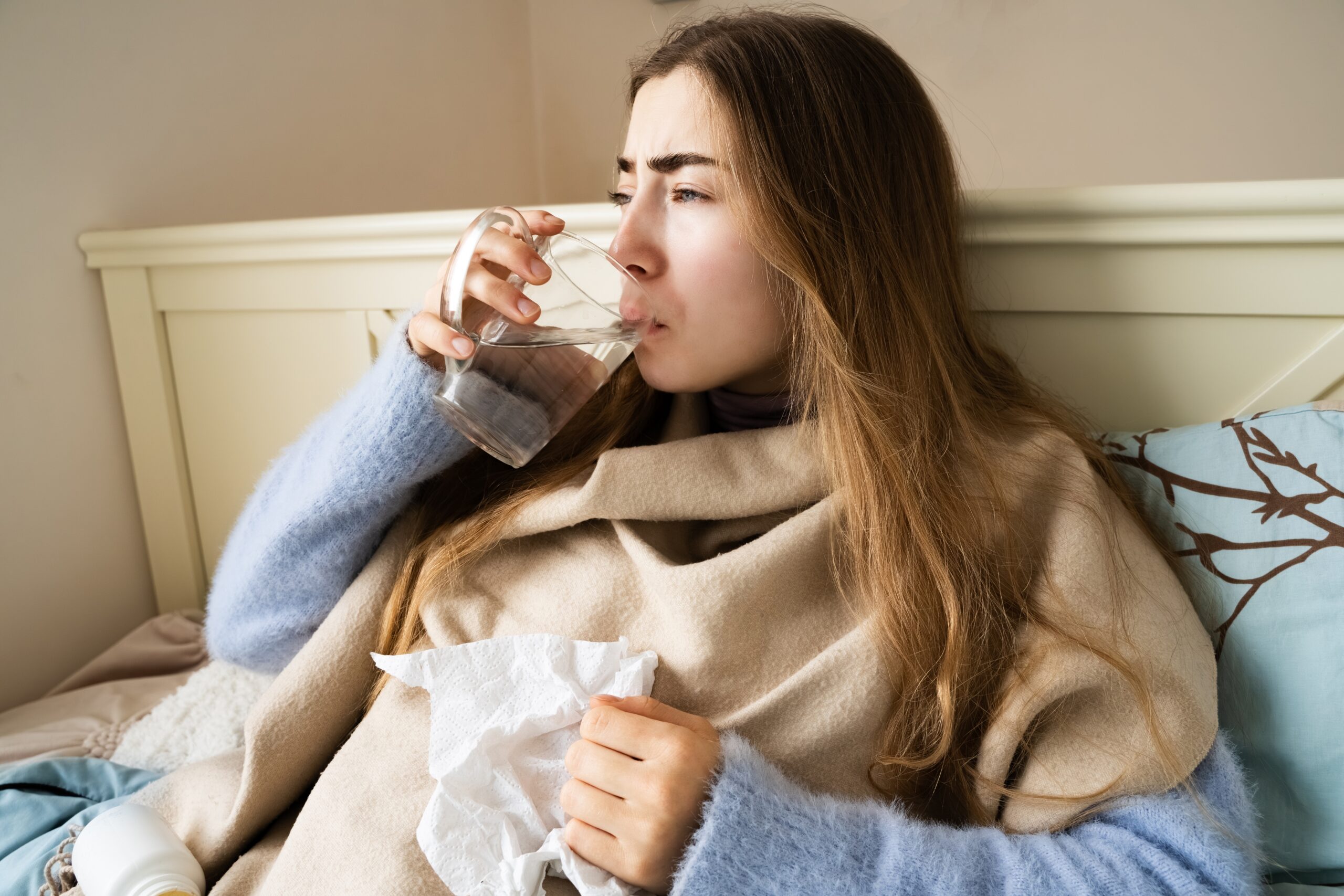 A woman home alone with the flu taking care of herself.