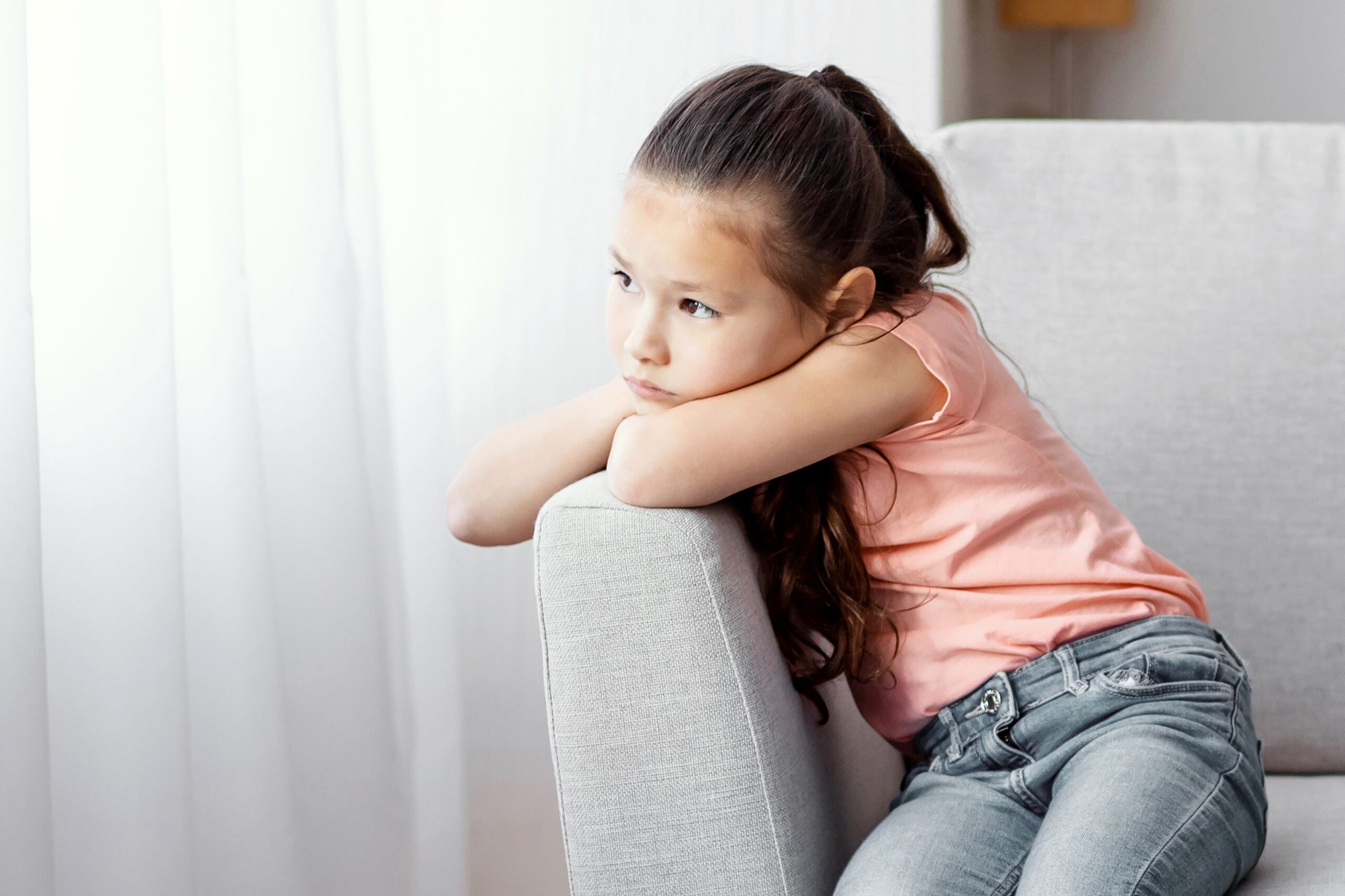A little girl sitting alone feeling unseen.