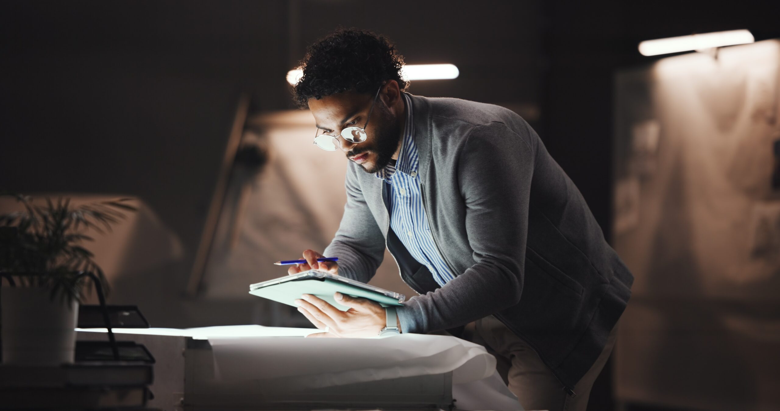 A man working at his desk at night.