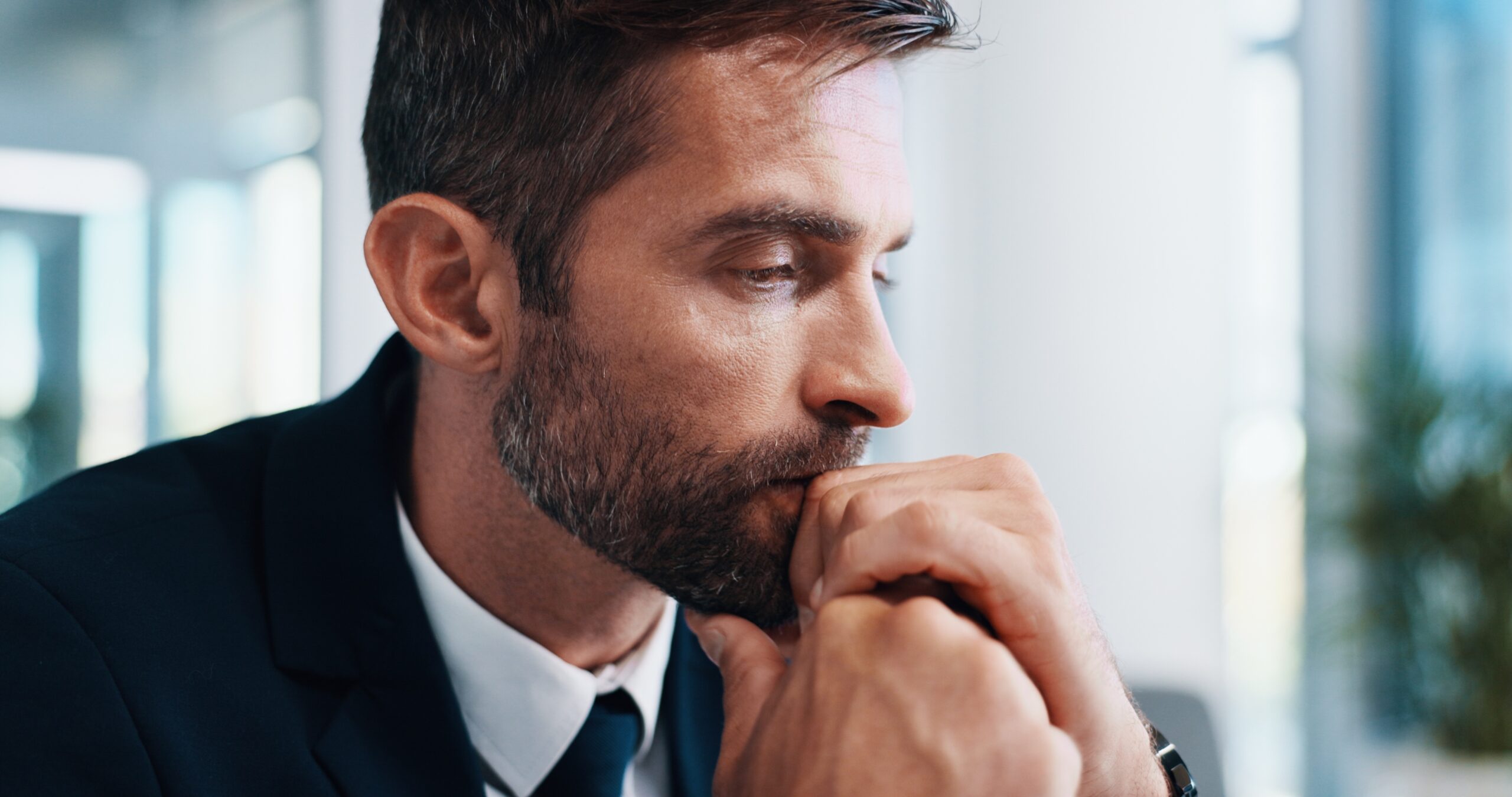Man looking stressed and unhappy at work.