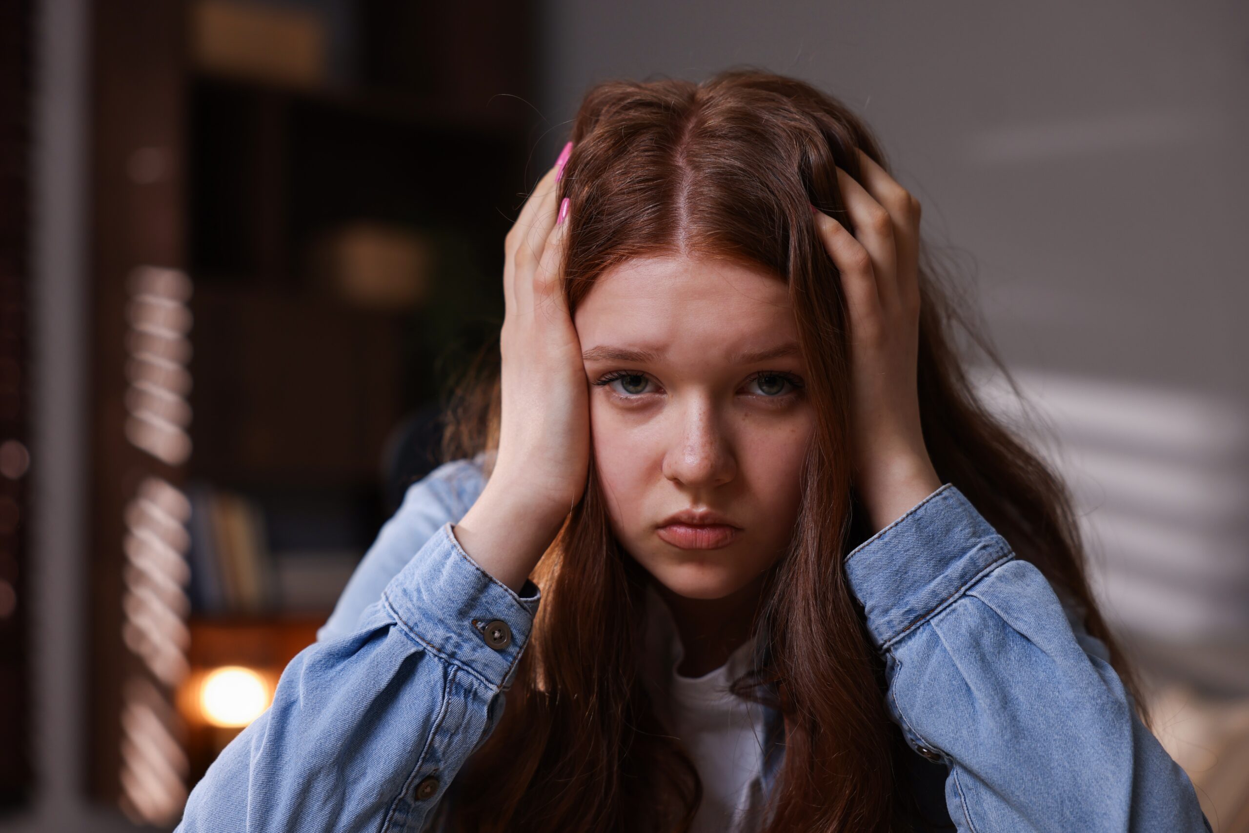 A frustrated teenage girl at home.