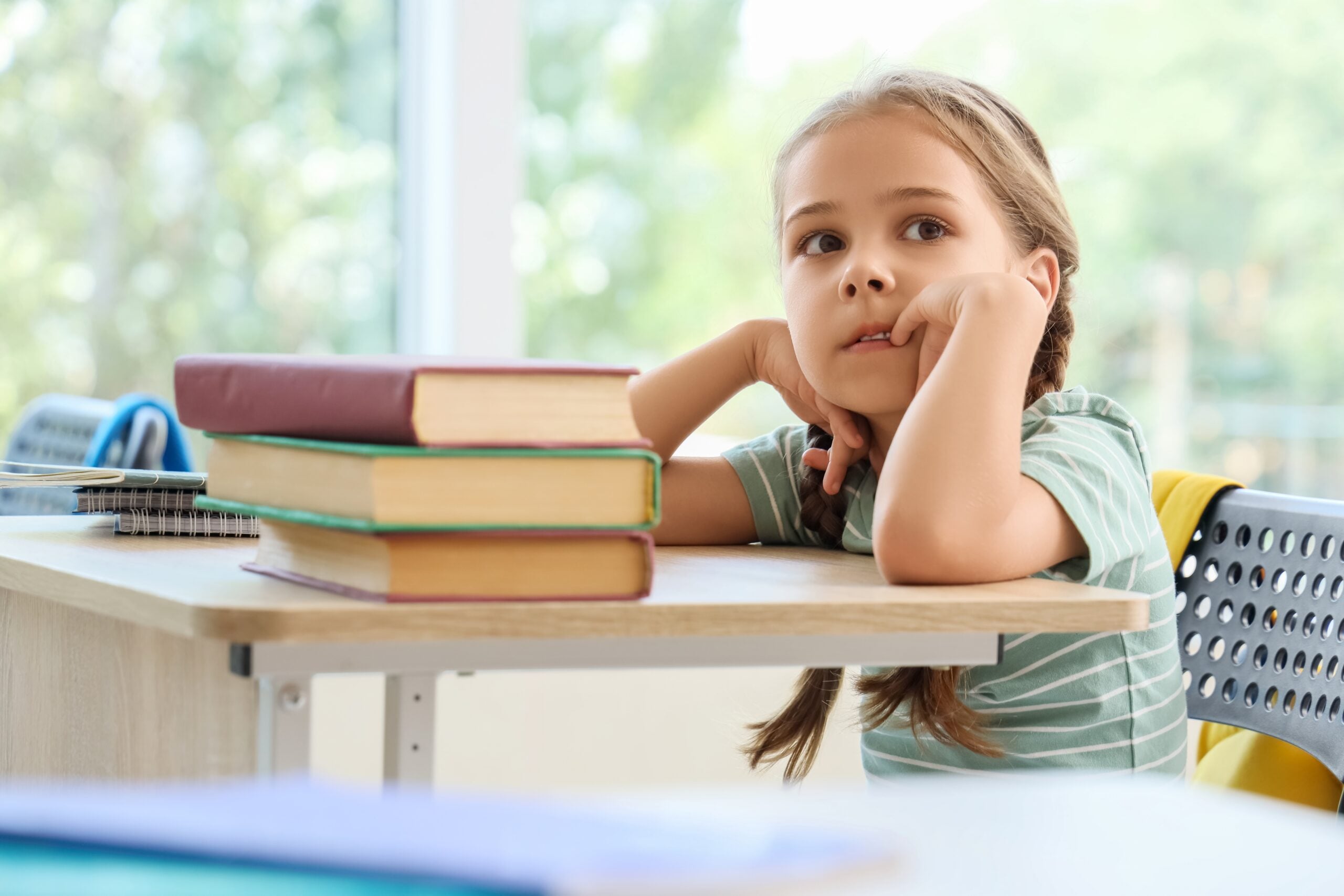 A little girl reading in school.