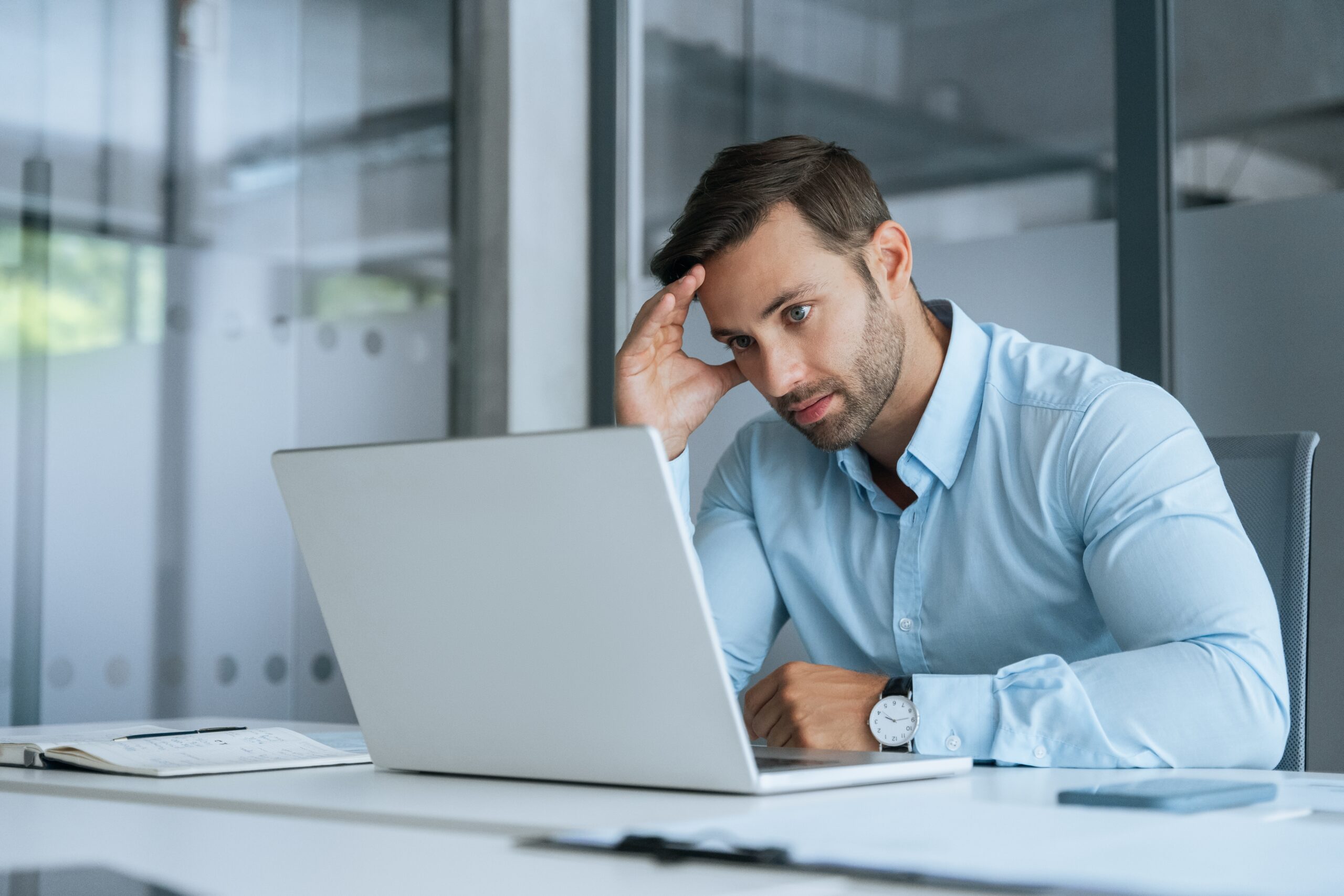 A man taking care of work and bills in his office.