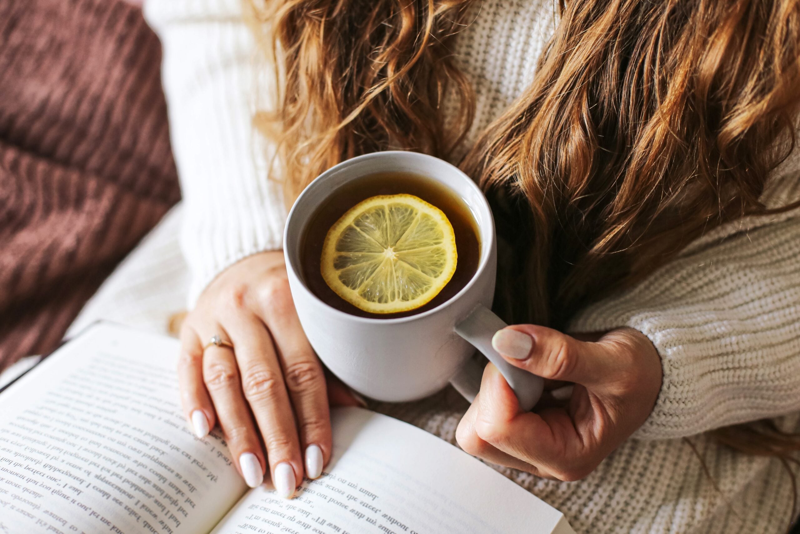A woman enjoying time alone with a cup of tea.