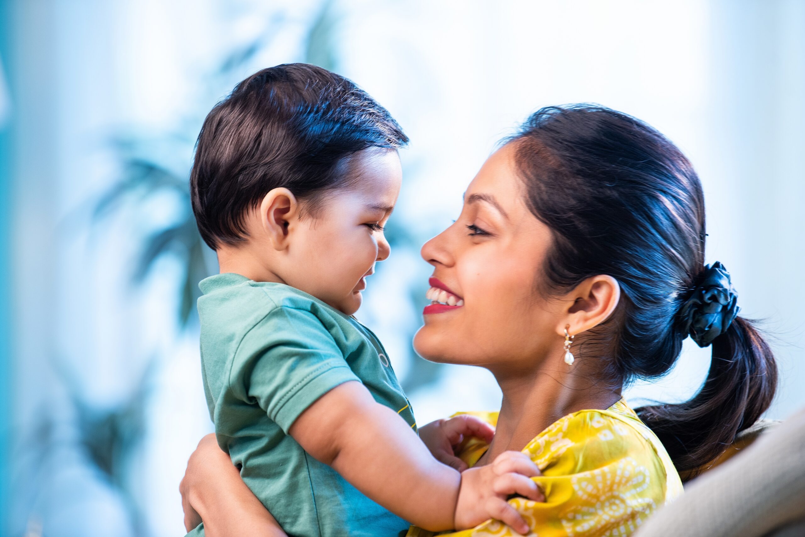 A happy young mother holding her child.
