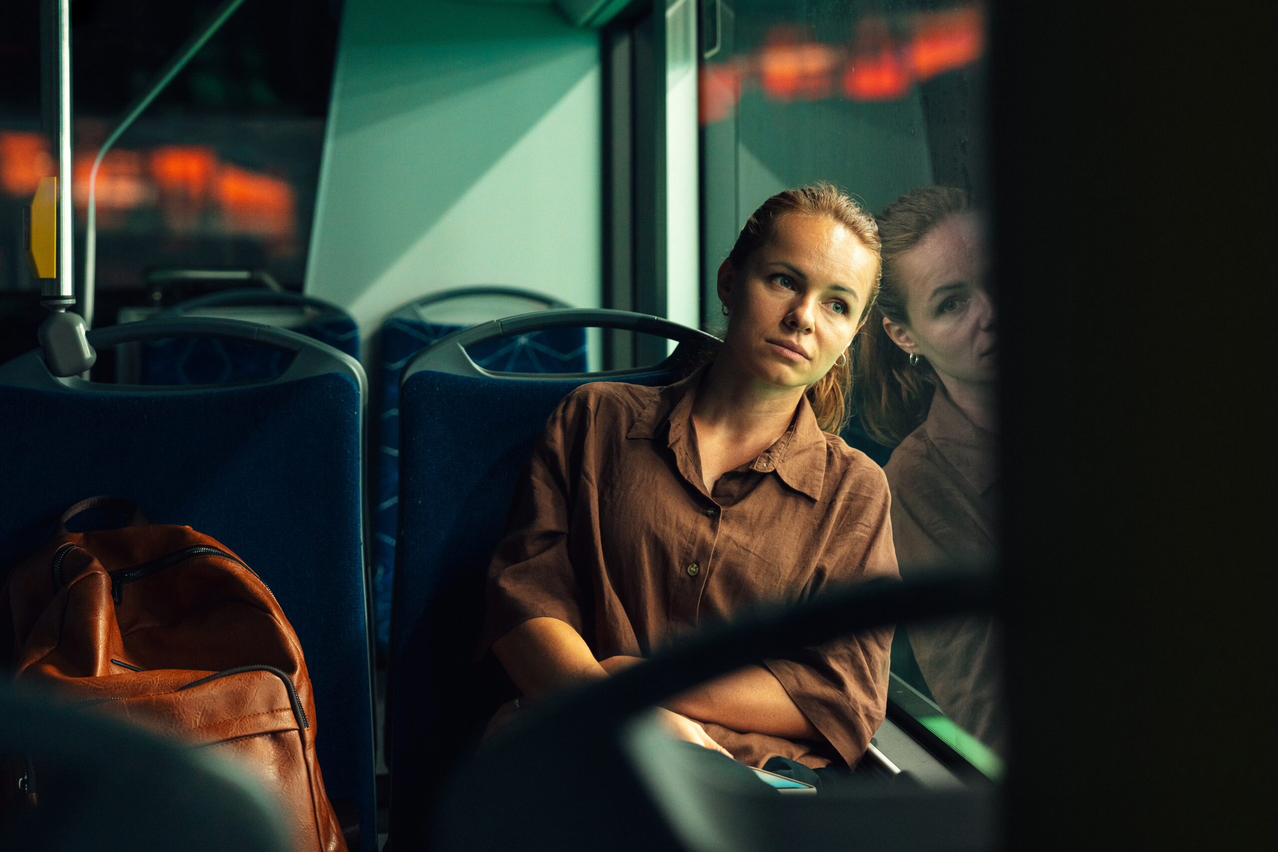 An exhausted woman on her bus ride home from work.