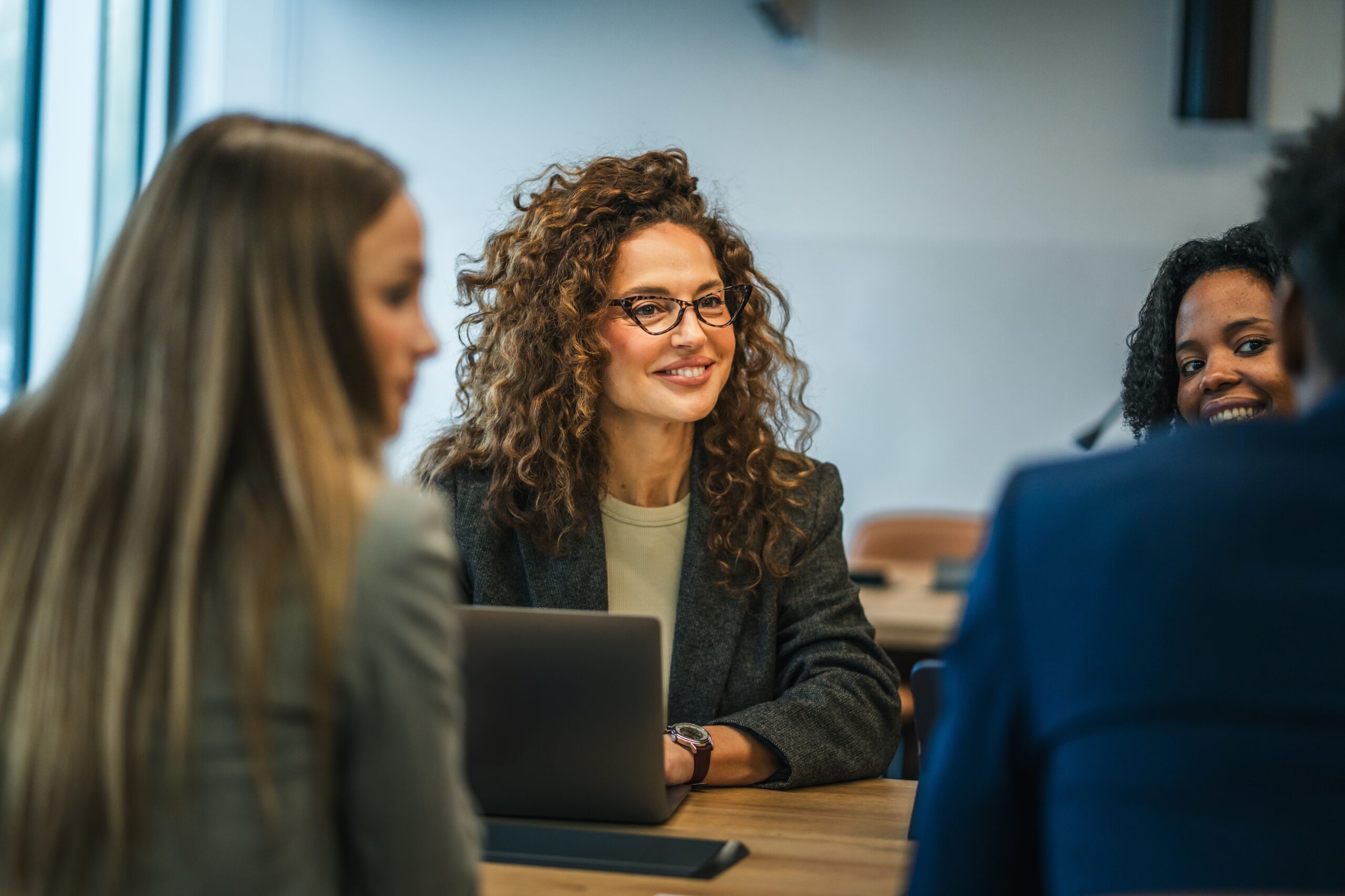 Professional businesswoman in a work meeting with colleagues.