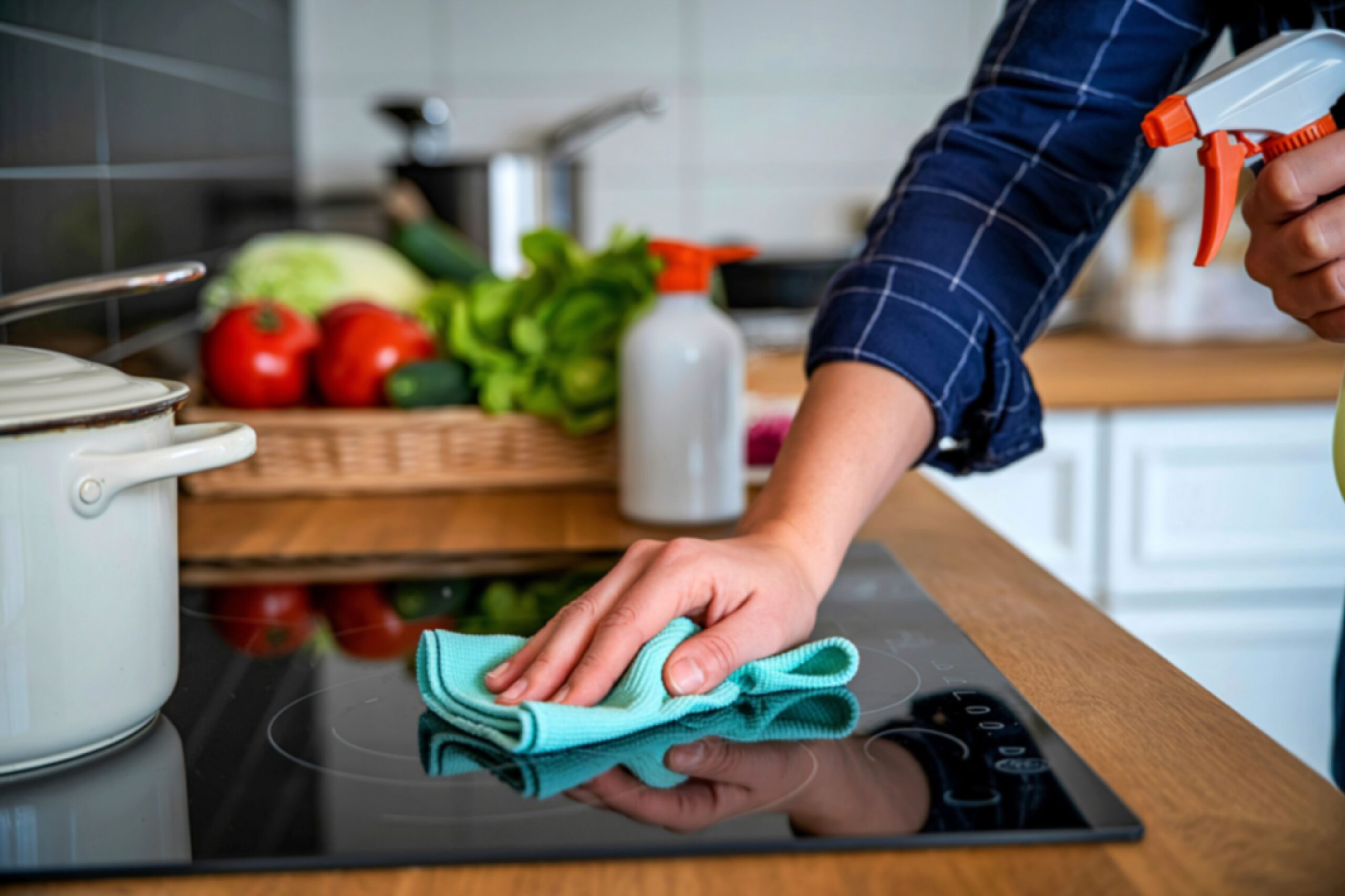 A man cooking and cleaning in the kitchen.