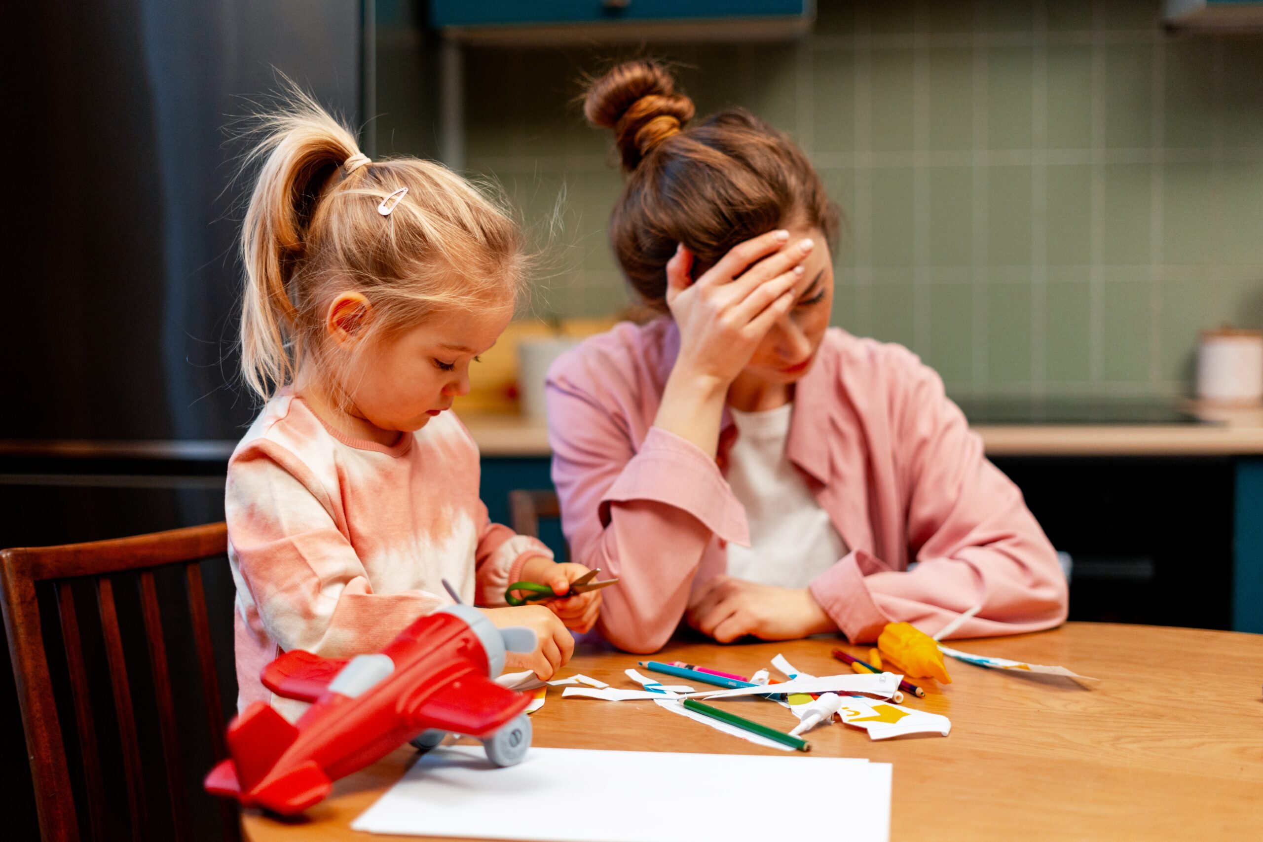 An overwhelmed mother with her daughter.