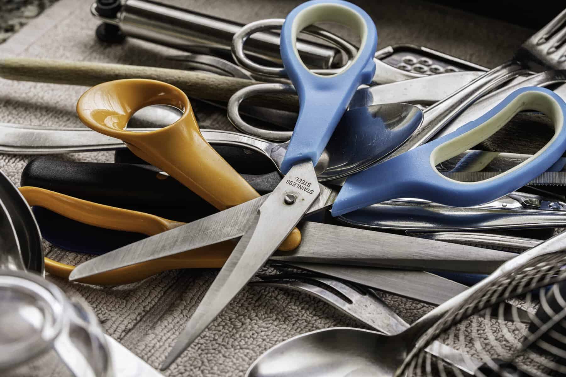 A messy kitchen drawer that needs organizing.
