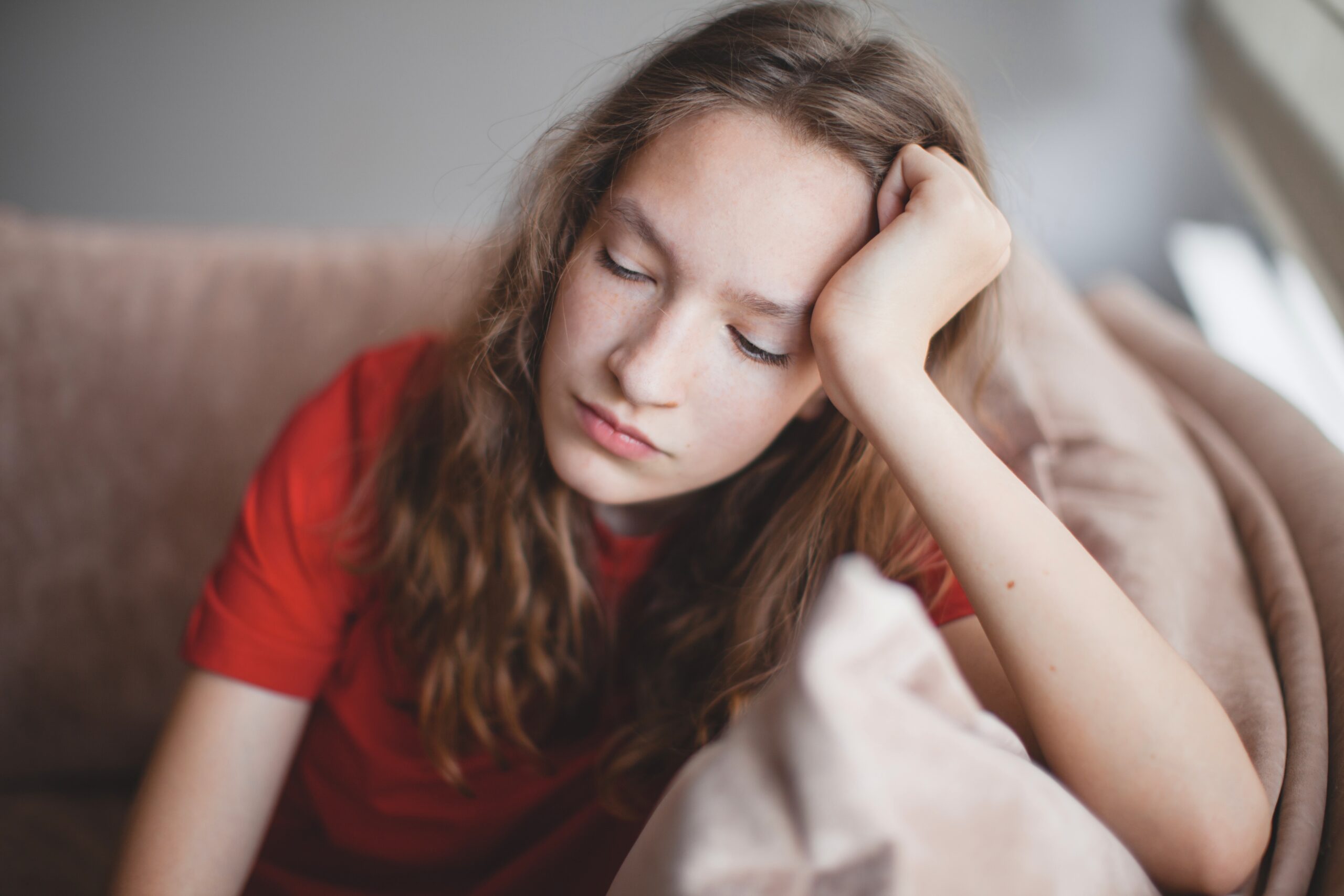 A depressed teen girl sitting alone.