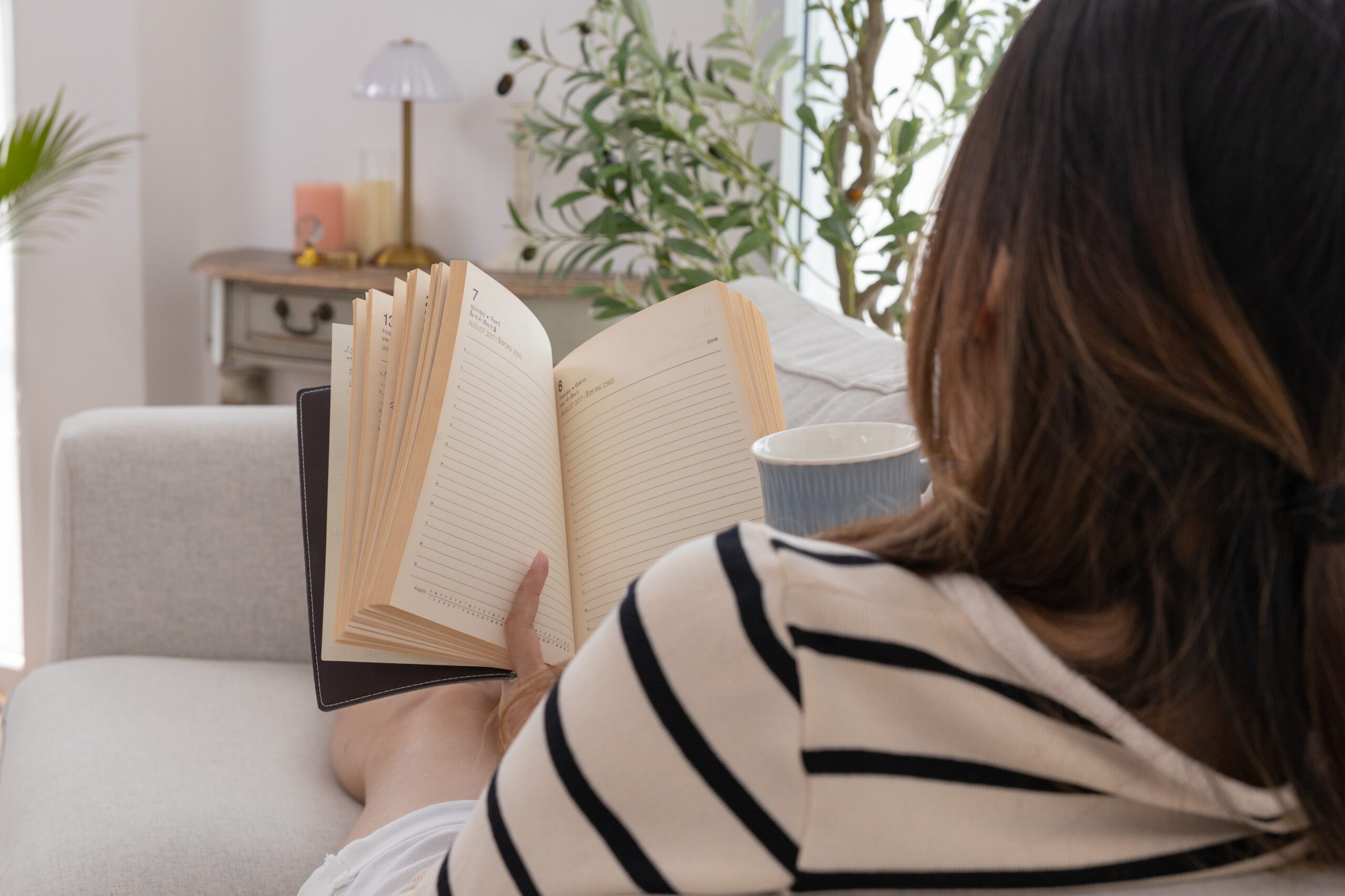 A proudly independent woman reading alone at home.
