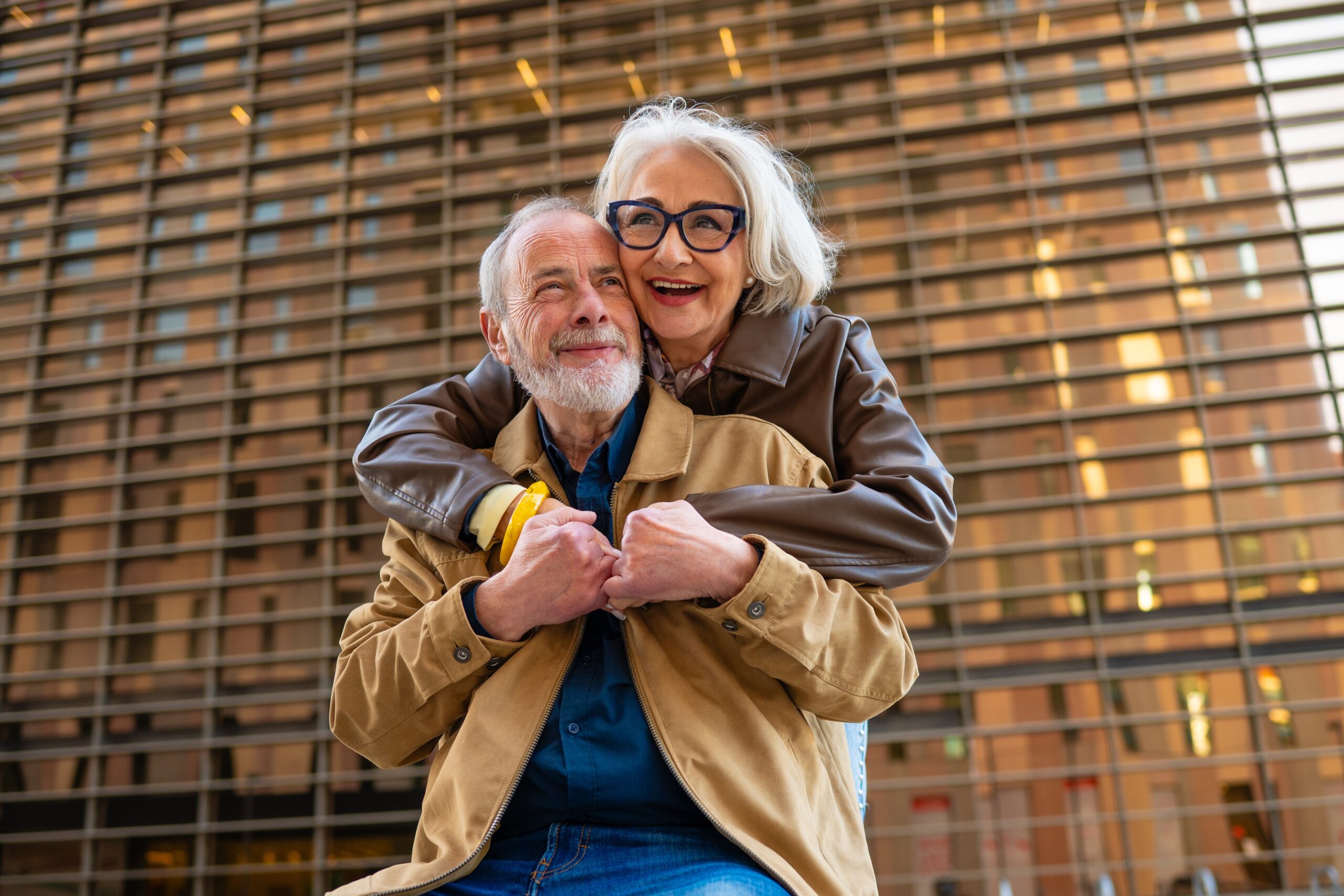 A senior couple embracing on a walk.