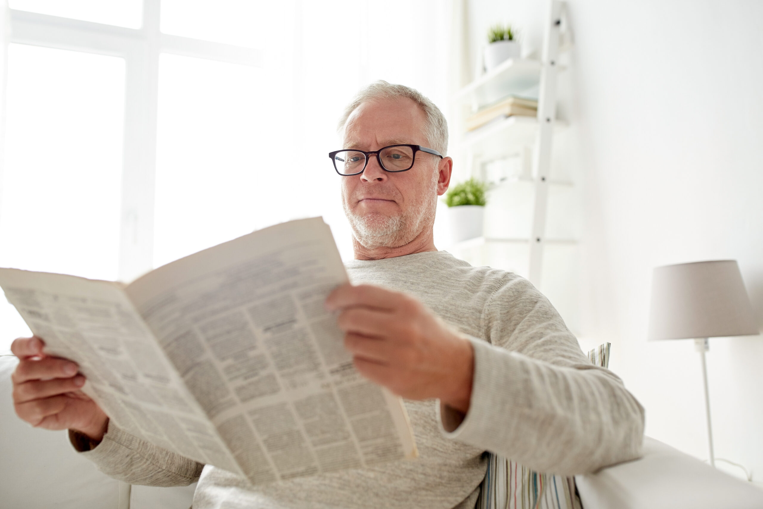 A man cynically reading the latest news.