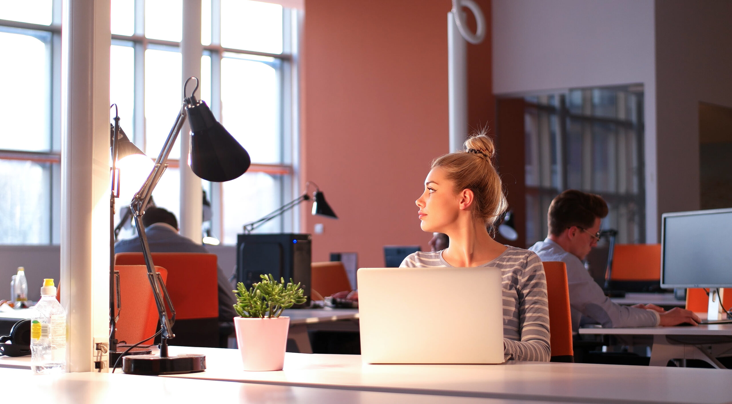 A woman sitting at her desk job.