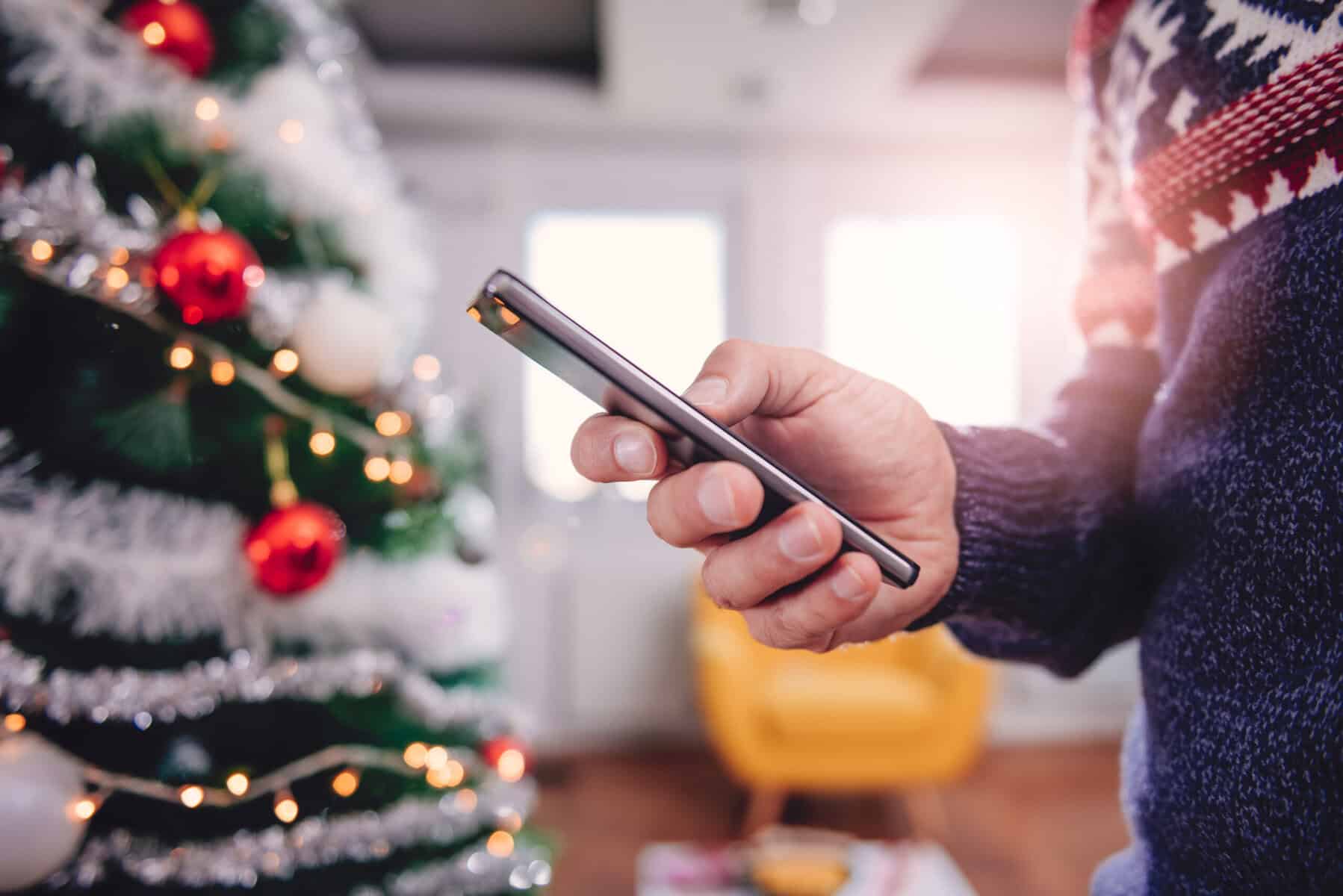 A senior man waiting for his child's call on Christmas.
