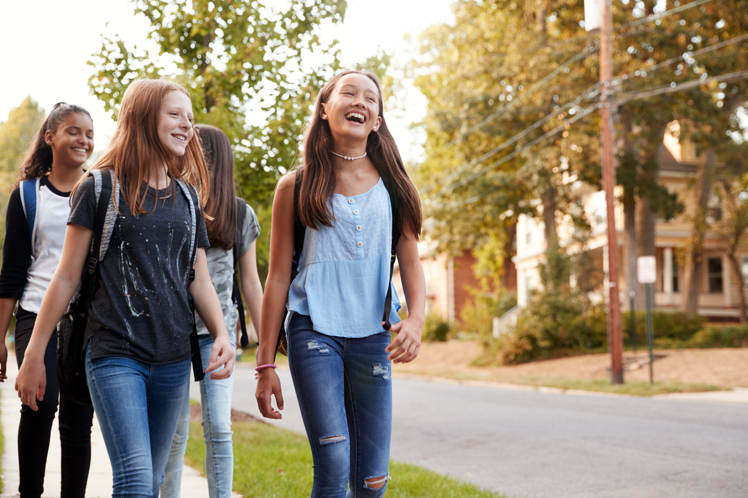 Four teenage girls on a walk home from school.