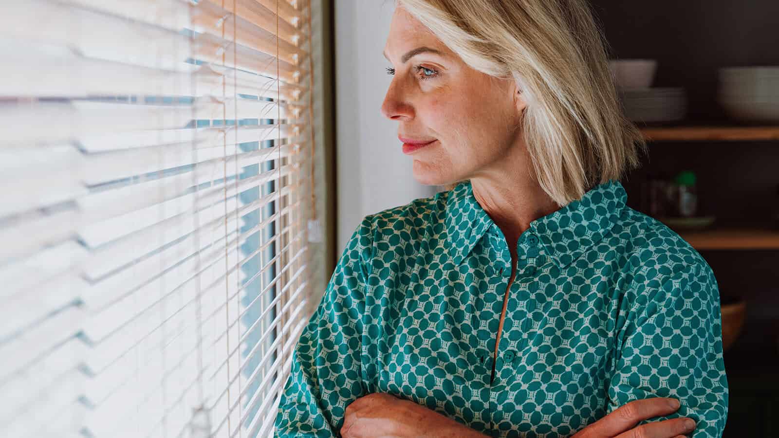 Woman looking pensively out the window.