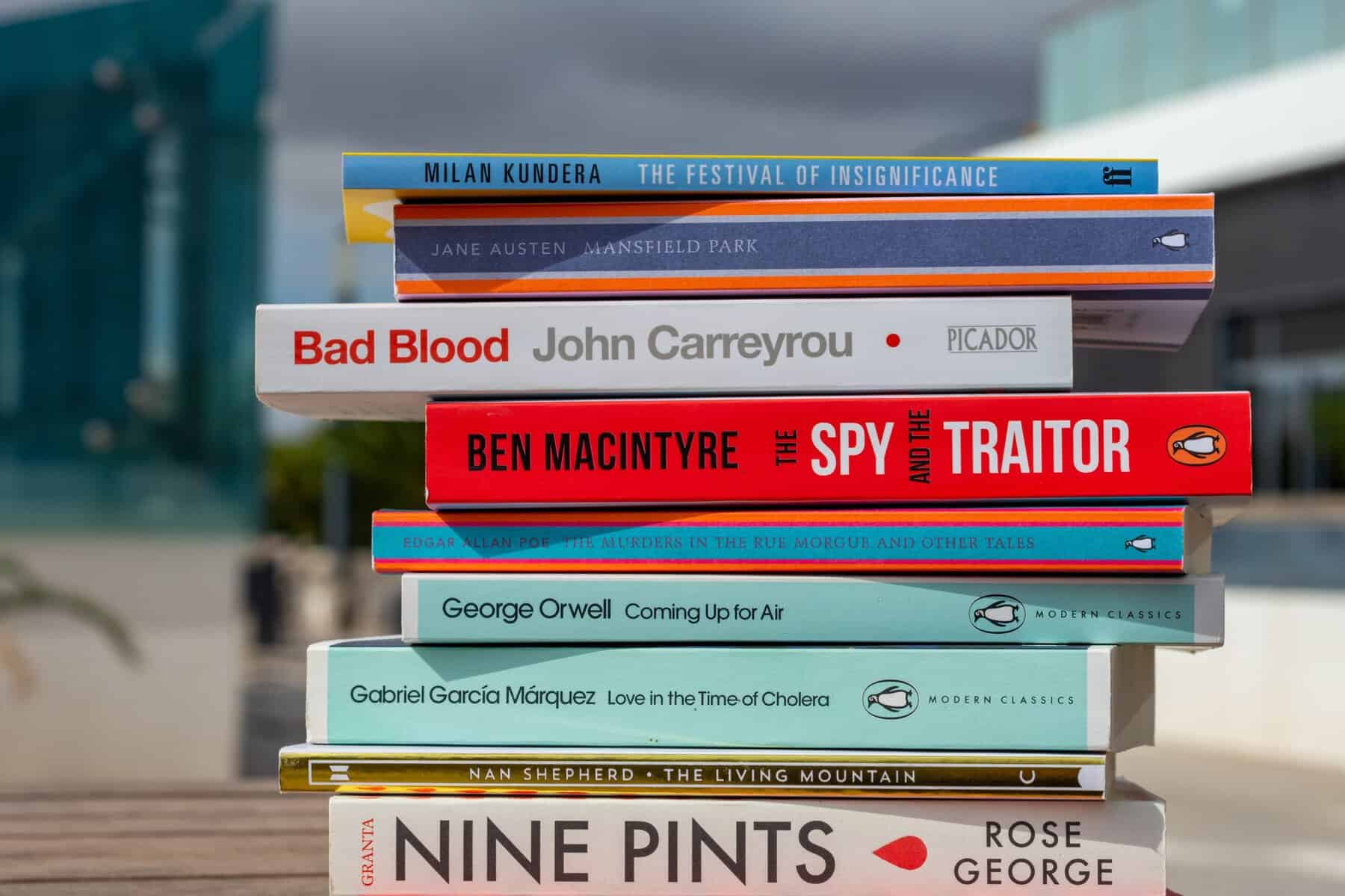 A stack of books being bought at the store.