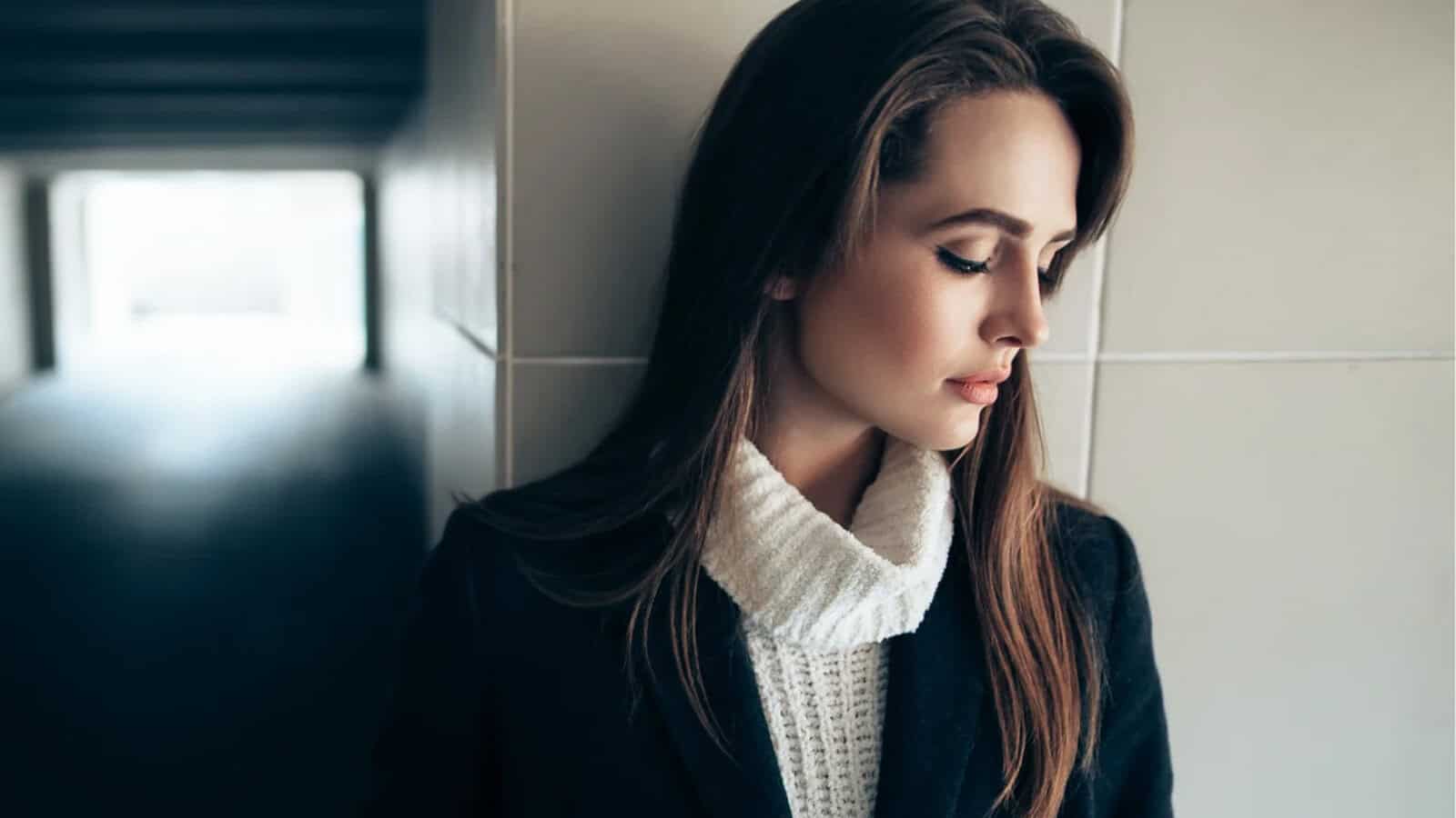 Beautiful lonely woman in a subway tunnel.