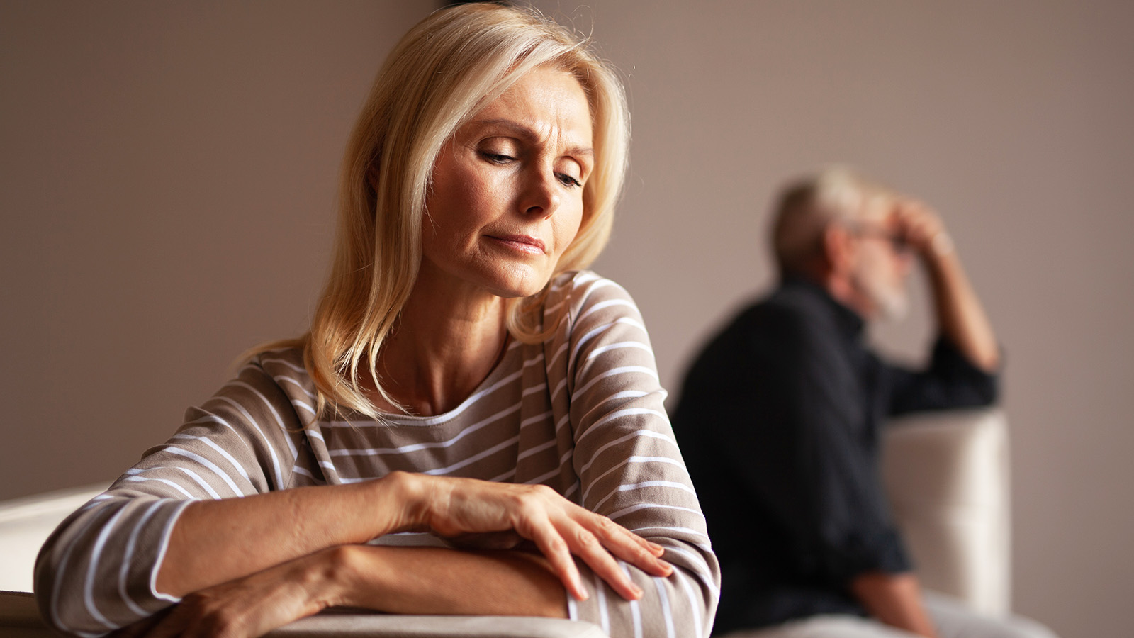 The older couple has a conflict. Upset mature woman, quarrel with her husband. Relationship crisis.