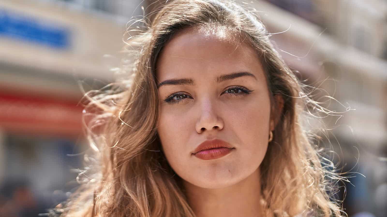 Close-up portrait of a woman looking directly at the camera.
